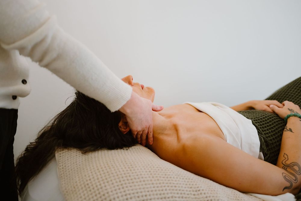 Professional massage therapy session showing hands performing therapeutic techniques.