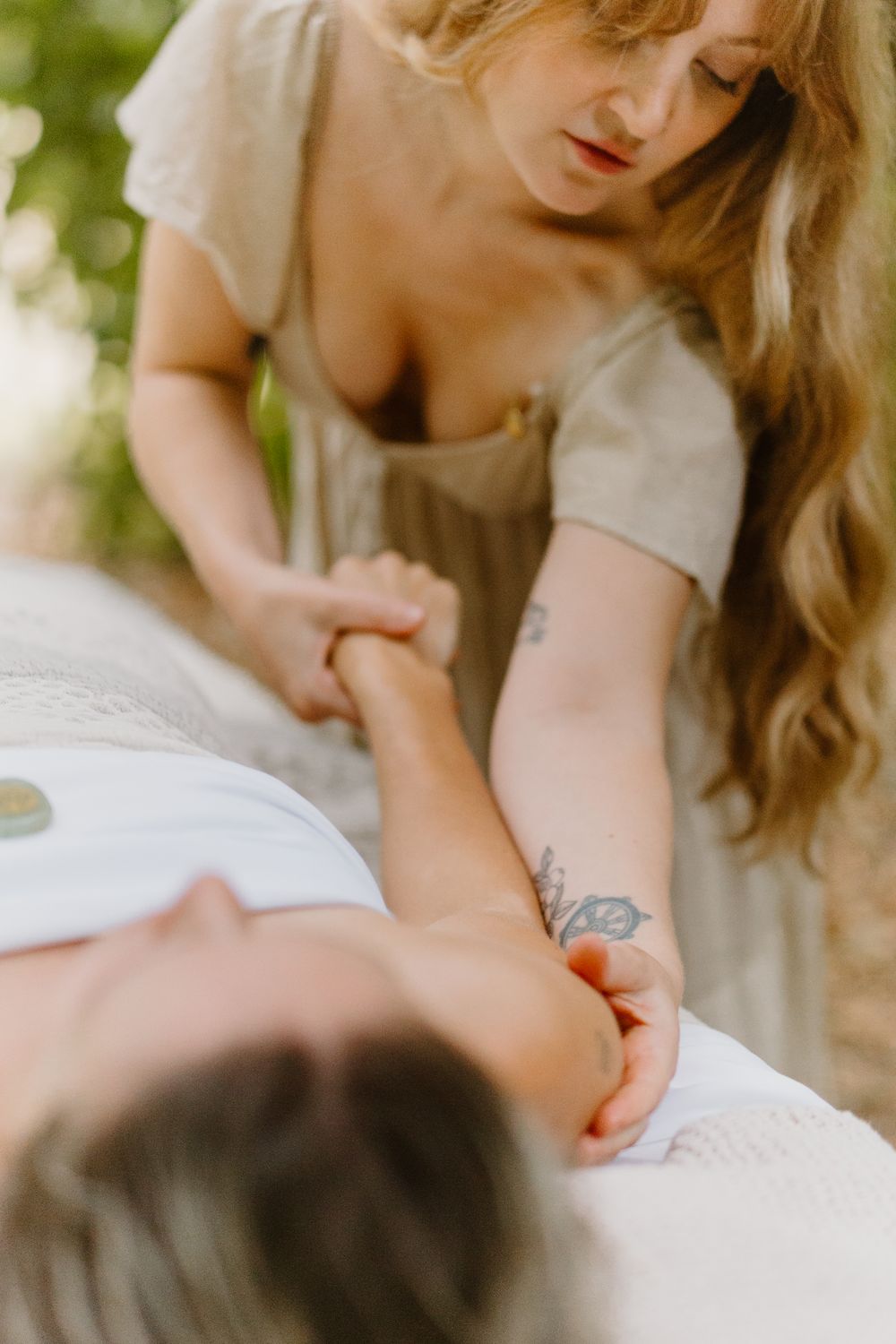 A close-up sequence showing hands gently massaging and applying therapeutic pressure during a massage session.