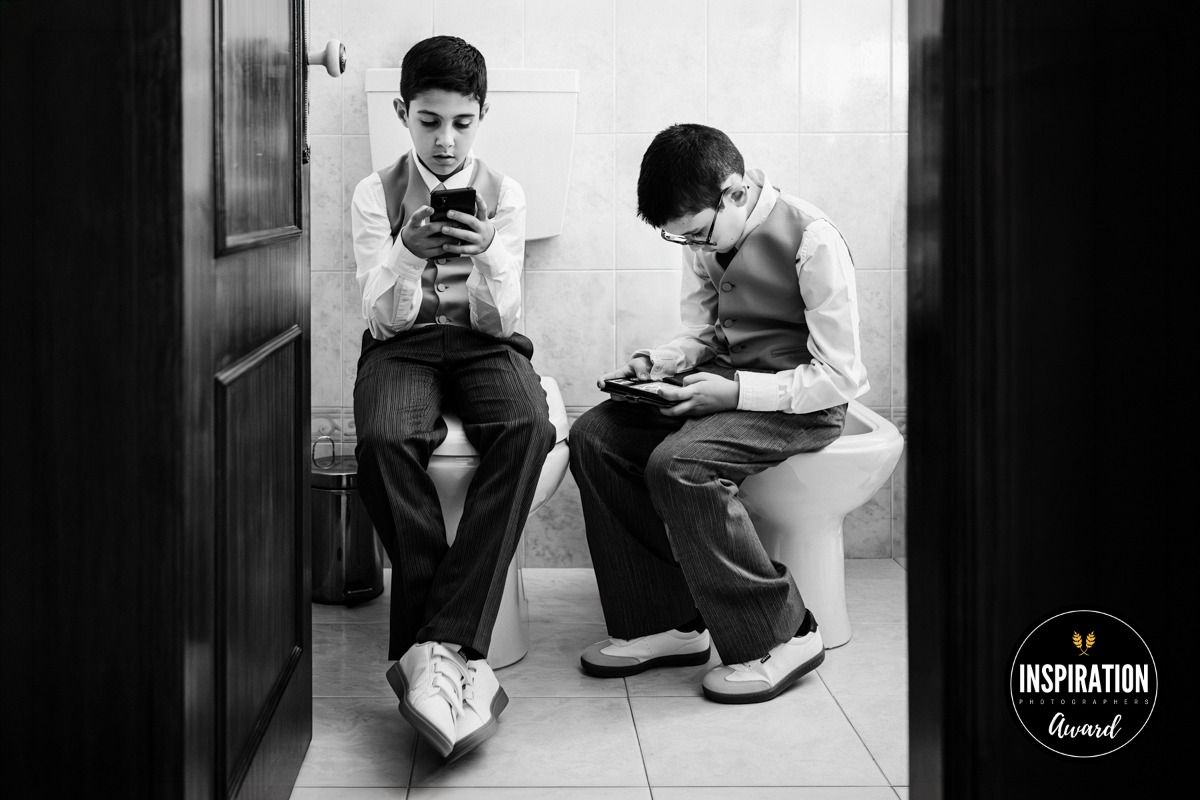 A black and white photo collage showing five people in different poses while looking at their mobile phones.