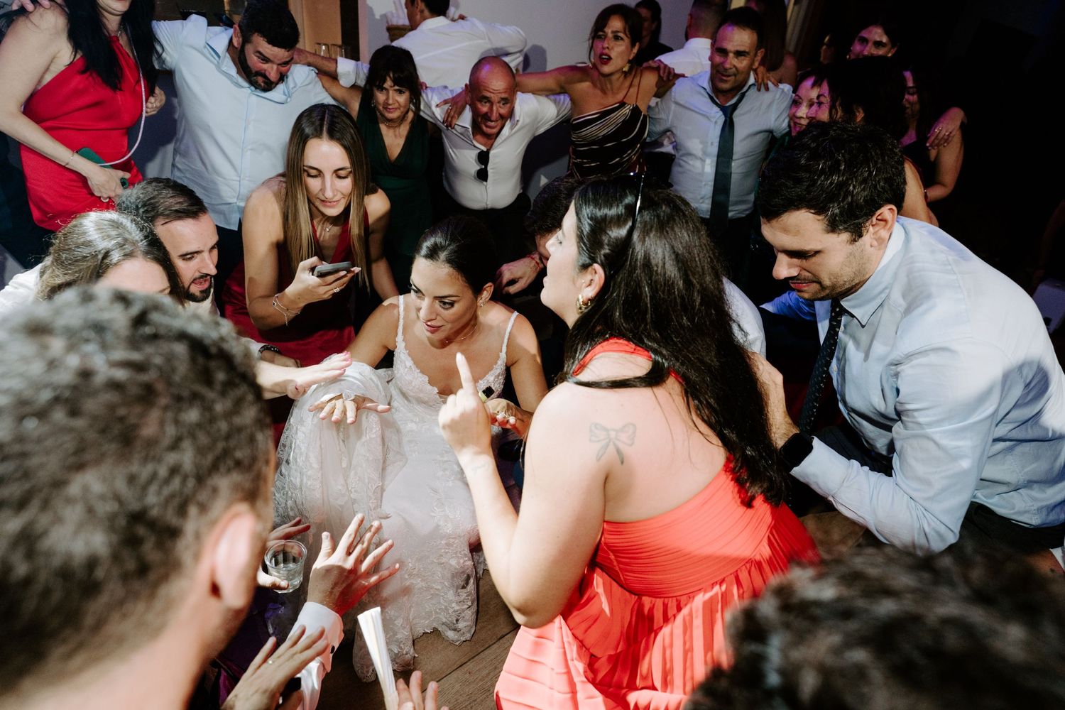 Wedding guests gathered in a circle on the dance floor.