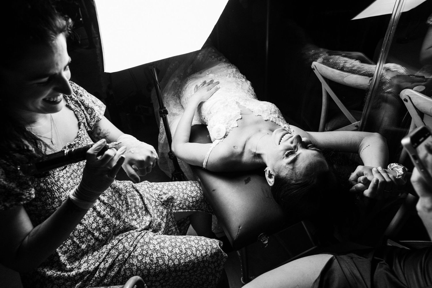 Black and white photo of a newborn baby being held during a birth photography session.