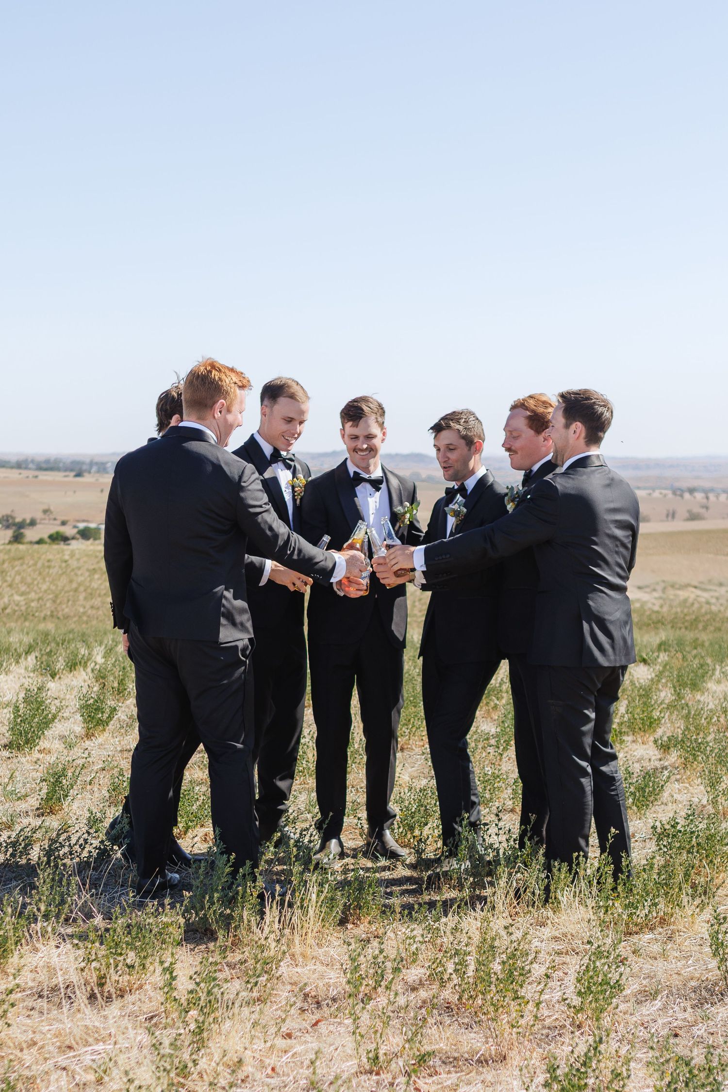 groomsmen cheersing their beers at country NSW Wedding