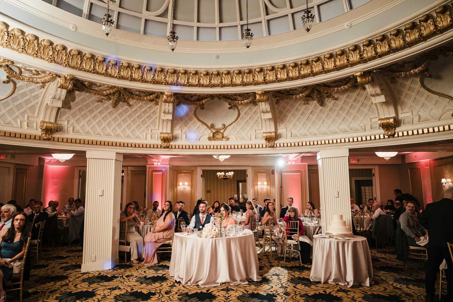 Wide view of guests seated in the Dome Room at the Lenox Hotel in Boston during wedding toasts, with ornate ceiling details above