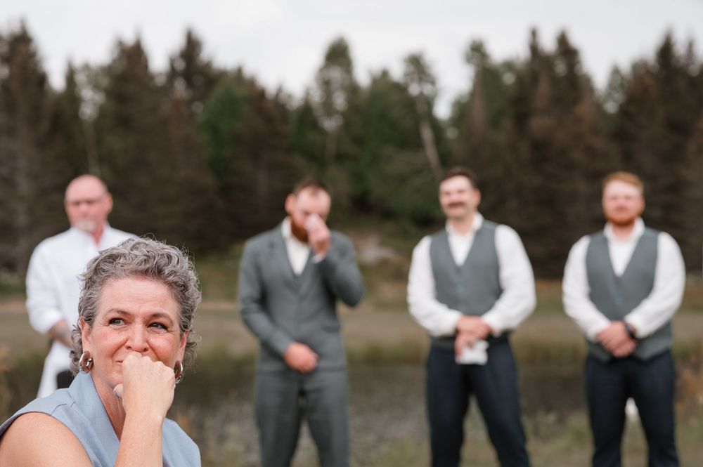 A sequence of emotional reactions captured at an outdoor event with evergreen trees in the background.