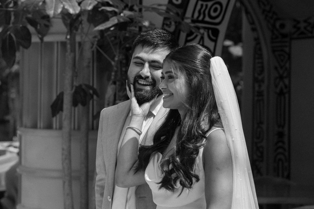 A joyful couple shares a tender moment during their wedding ceremony, surrounded by guests.