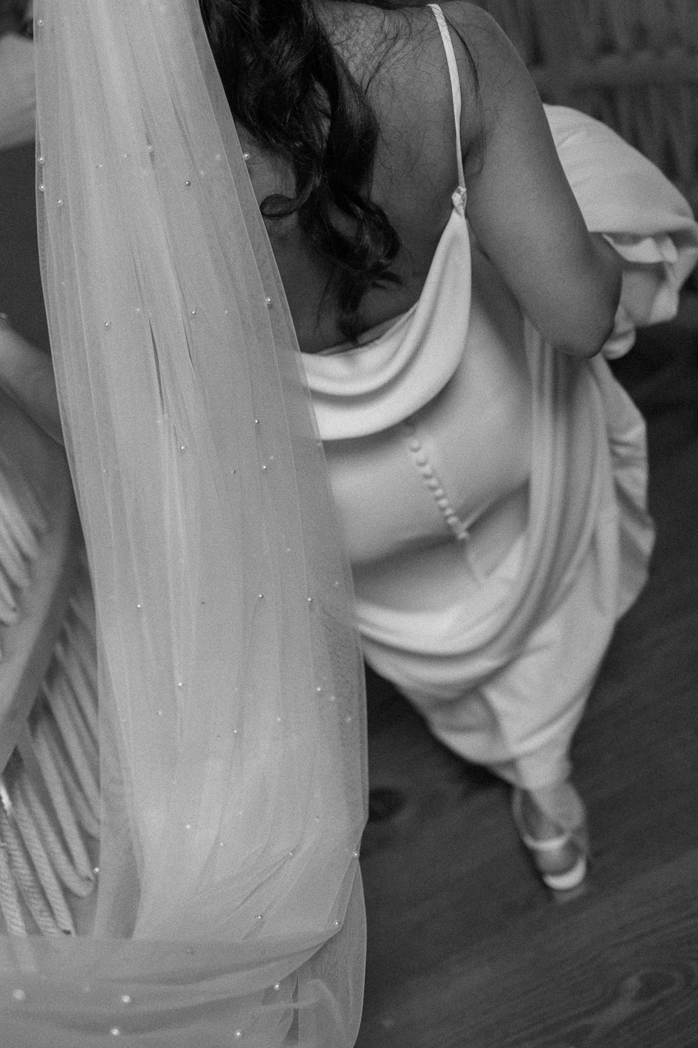 A sequence of black and white photos showing flowing fabric movement and graceful dance poses.