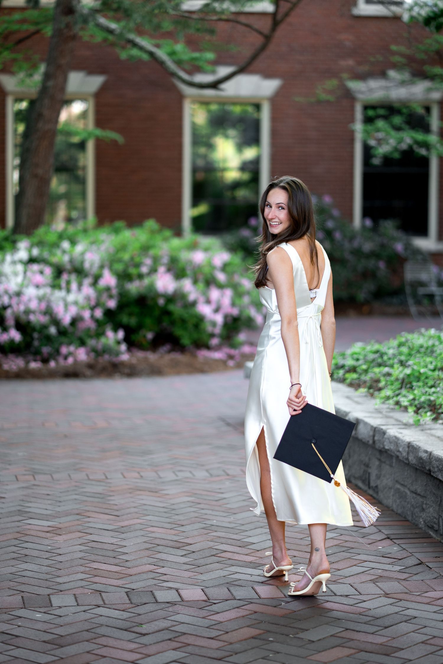 Smiling graduate poses for the best Atlanta grad photos at Georgia Tech with portraits by Pierre The Pear Photography