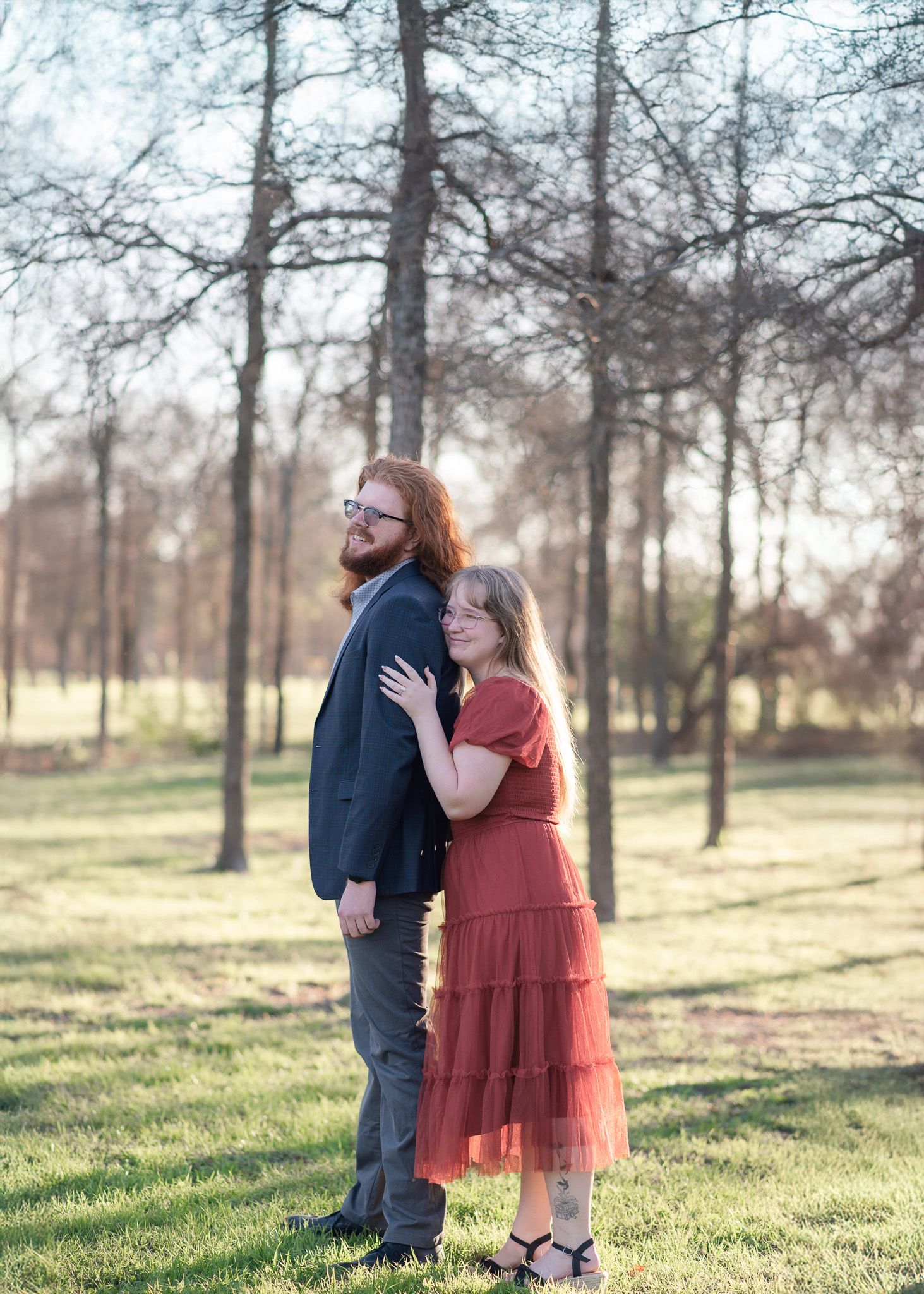 Newly engaged couple standing together at Pepper Creek Trail near Crossroads Park in Temple Texas during winter proposal session