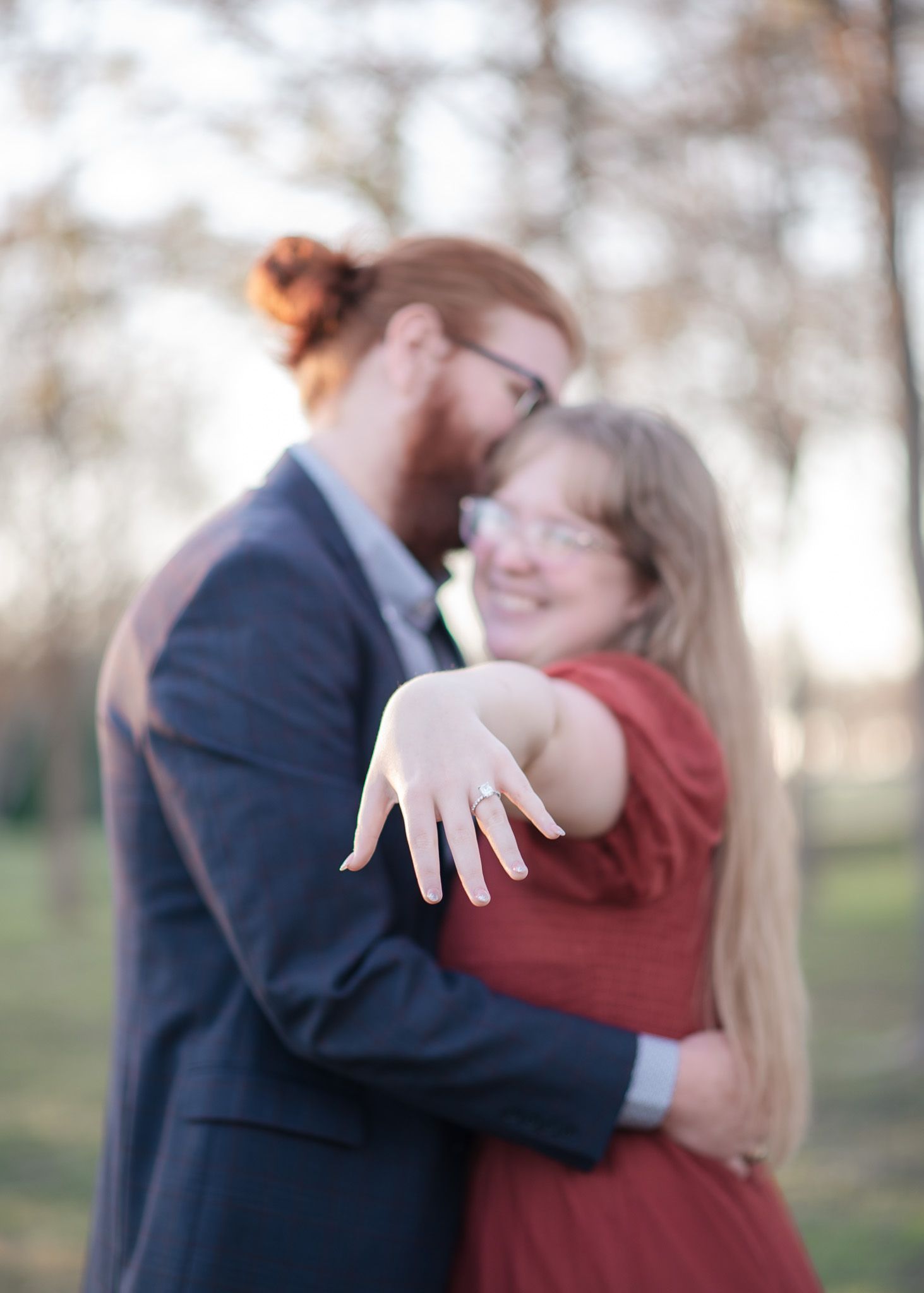 Romantic proposal moment at Pepper Creek Trail in Temple Texas with engaged couple embracing during golden hour