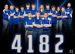 Minneota Viking Robotics team 4182 poses together in blue polo shirts for group photo.