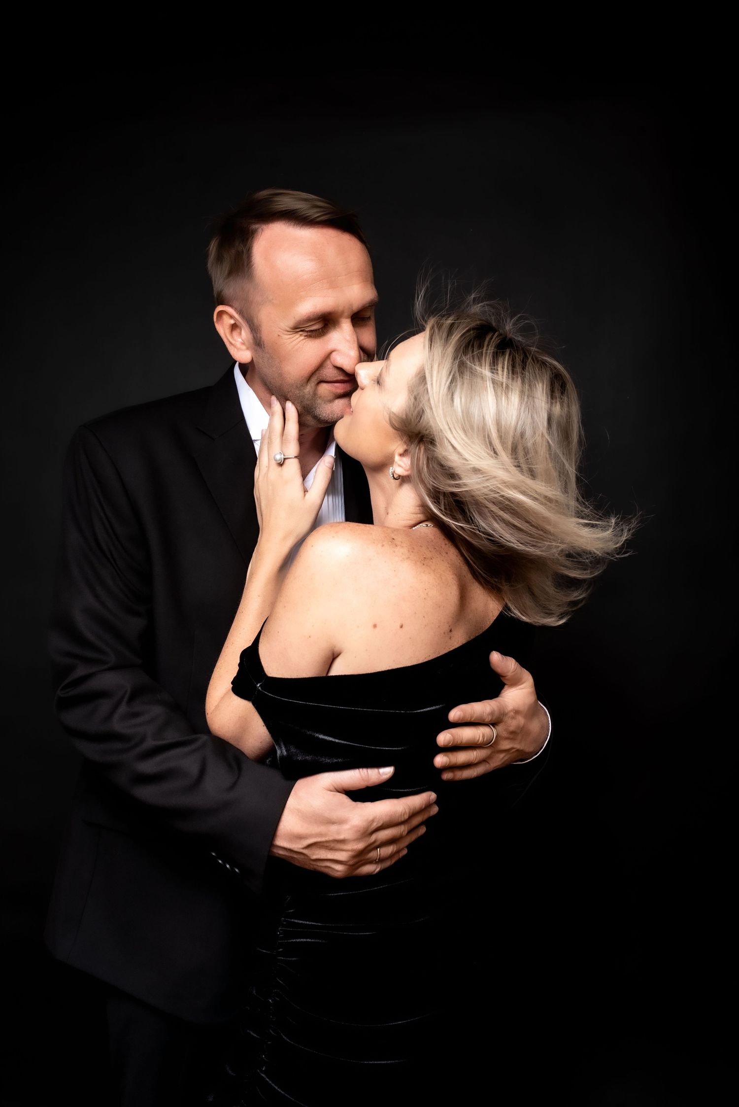 Elegant couple portrait on black background, timeless studio photography with formal dress and classic suit in Nashville studio