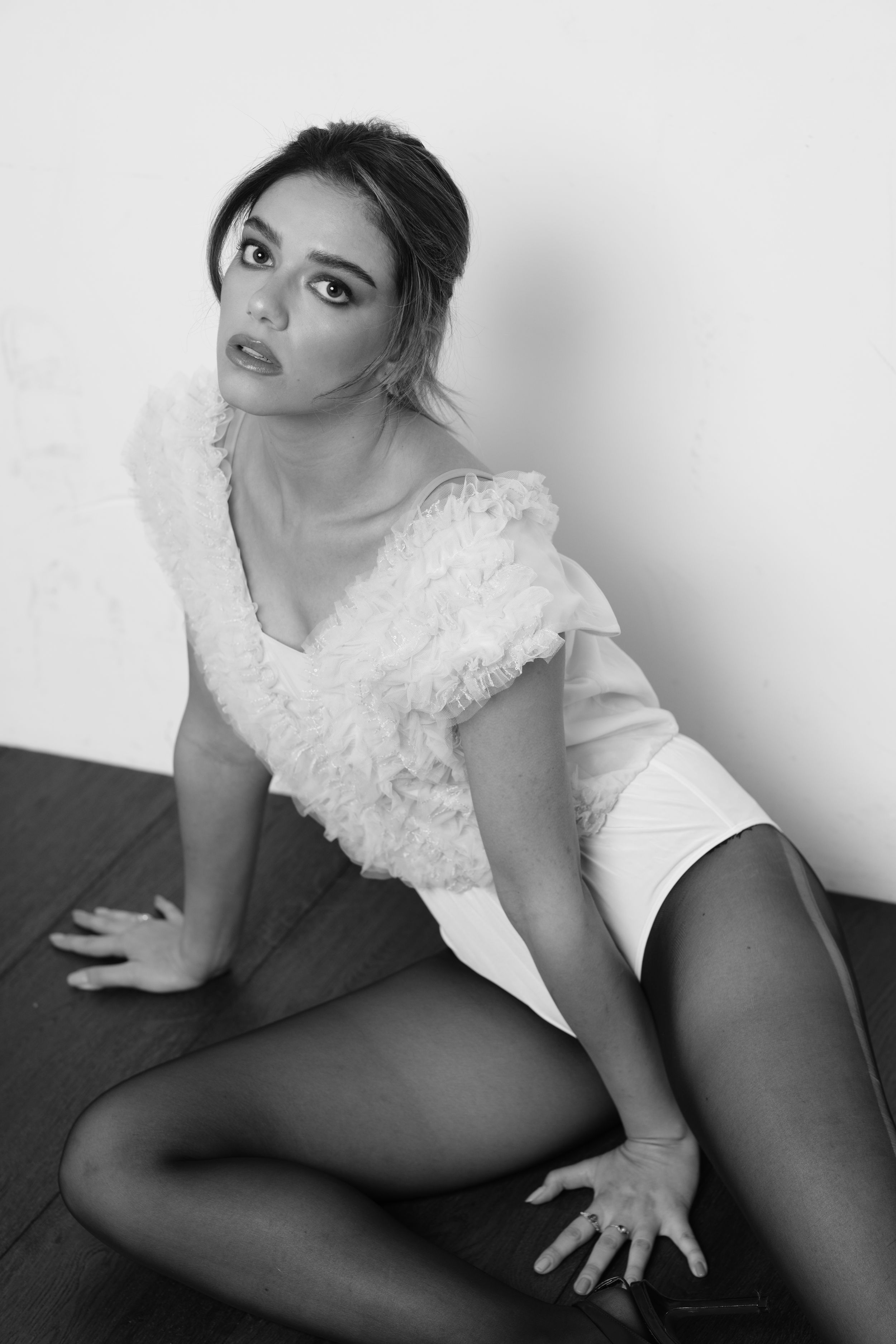 Monochrome photoshoot sequence showing dramatic poses in white lace attire.