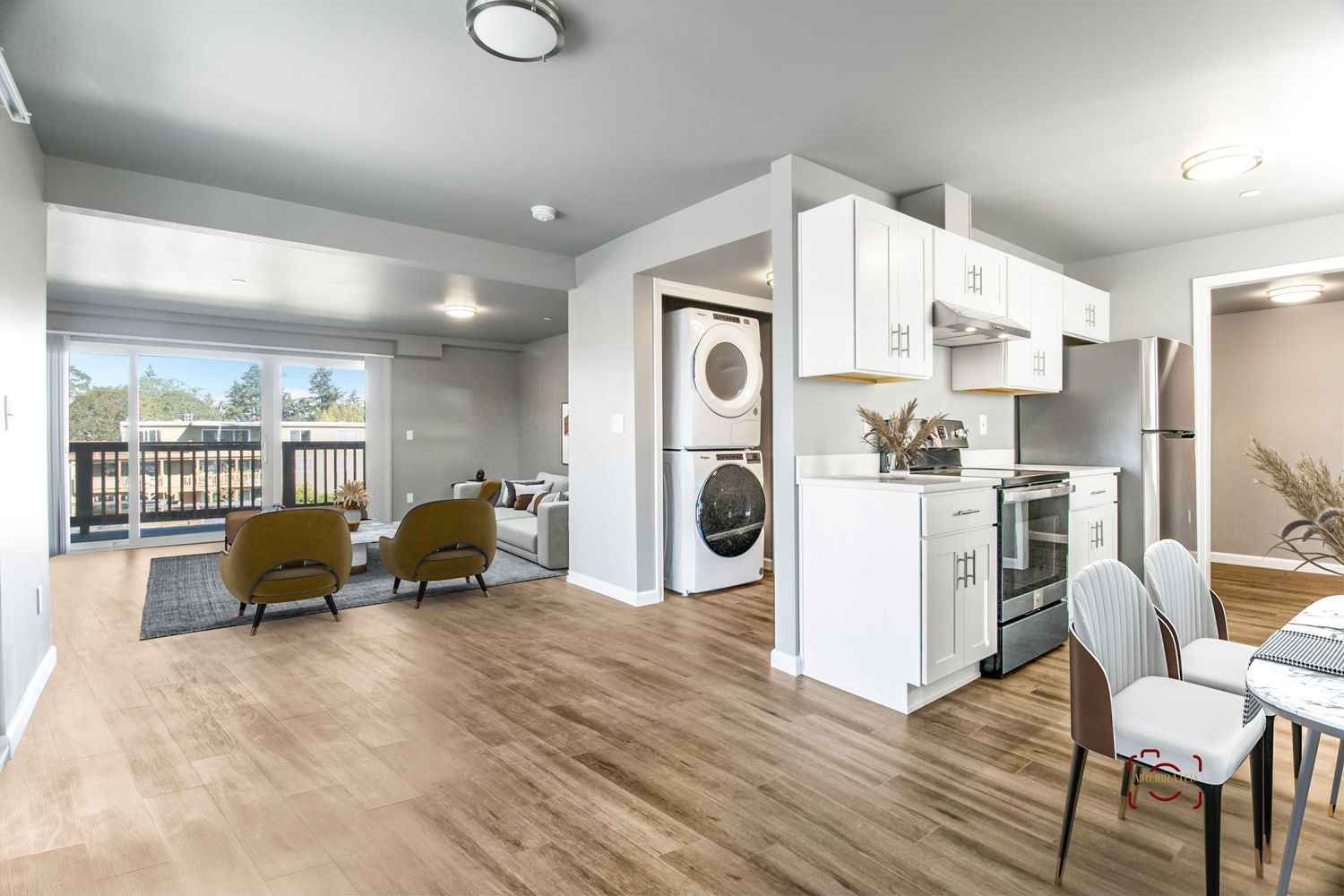 Contemporary open floor plan apartment with stackable laundry and bright natural lighting.