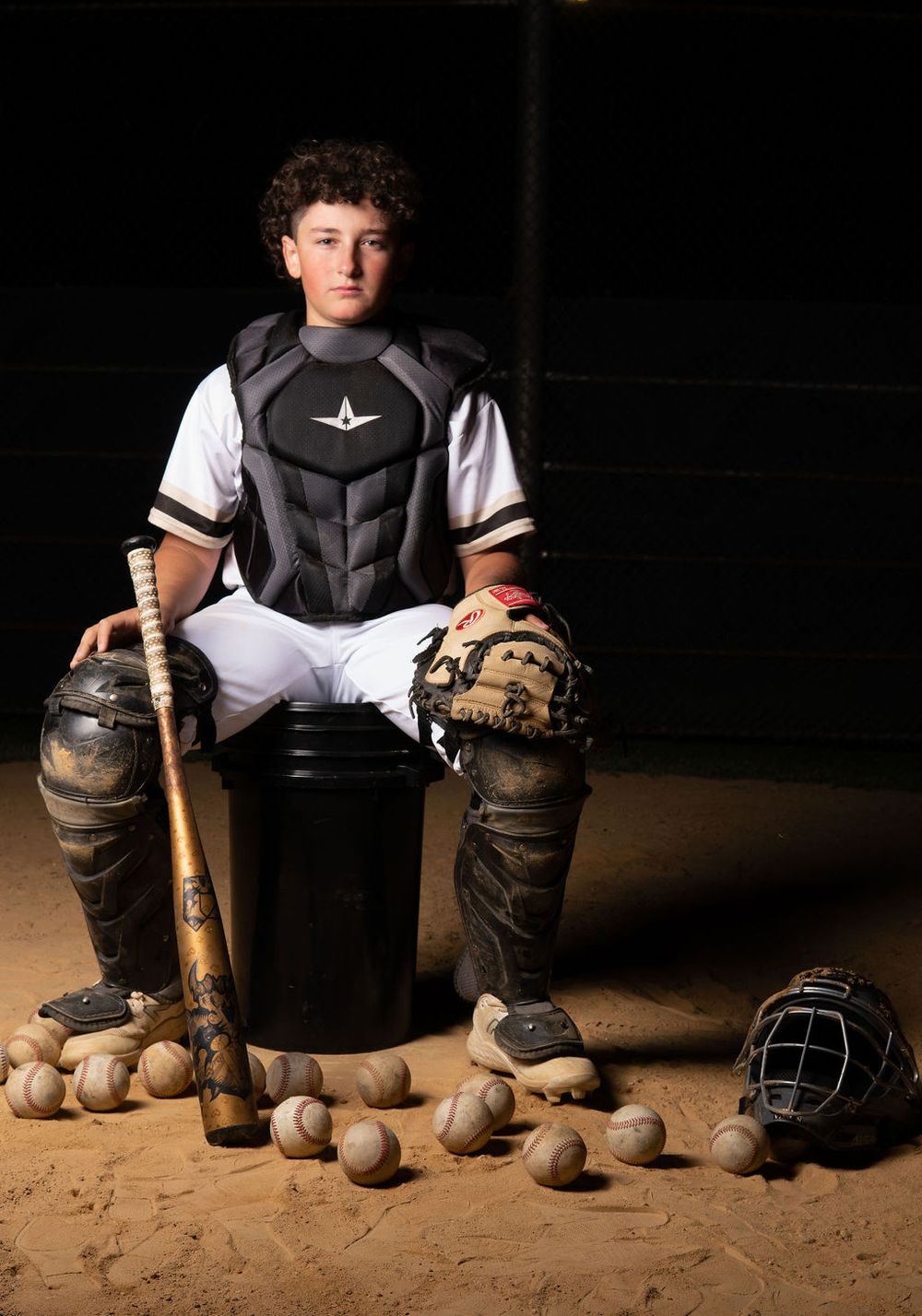 Long Island High School Baseball Player portrait session with dark and moody dynamic lighting.