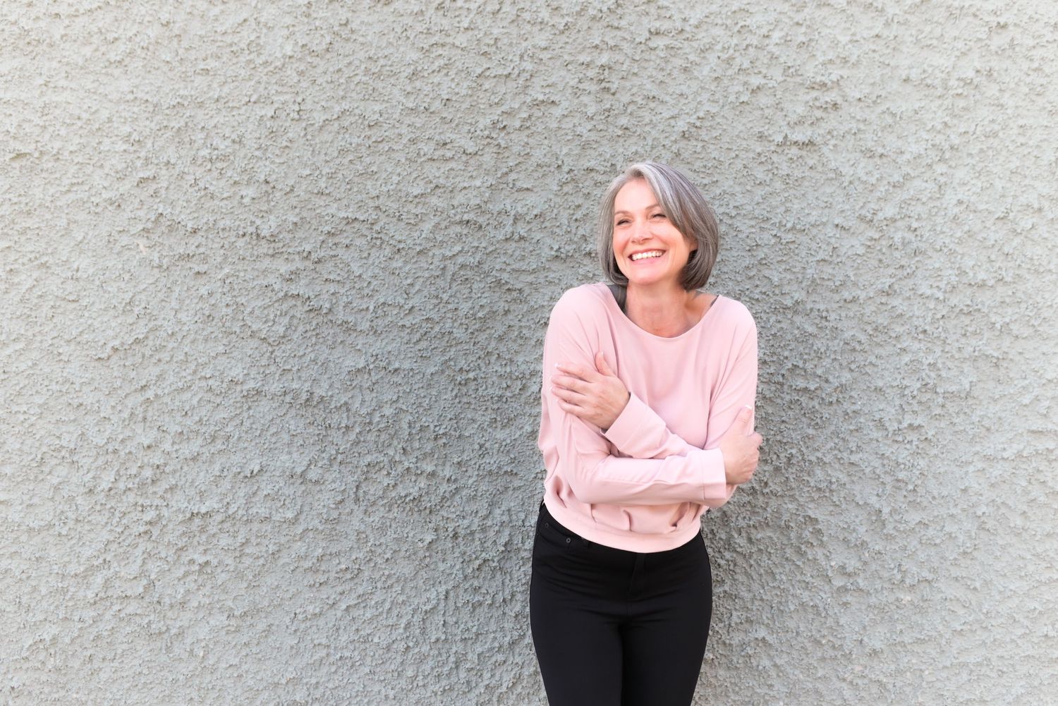 Casual lifestyle portraits against textured wall showing various expressions and poses.