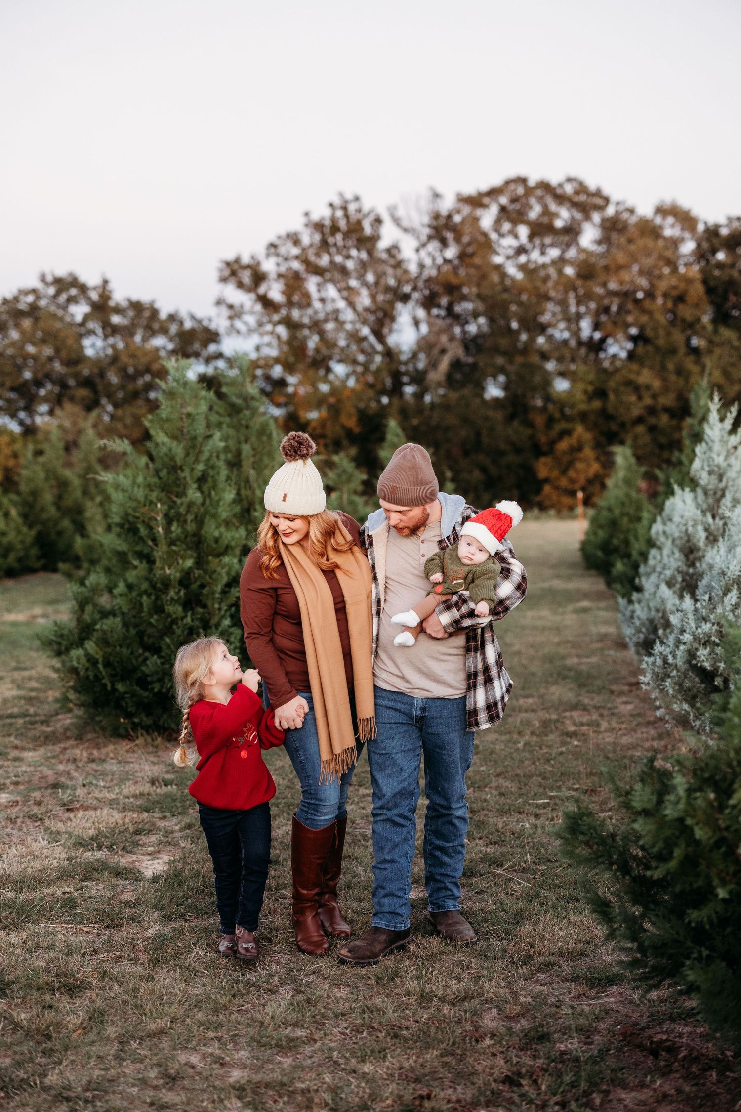 A family enjoying a playful moment together in a rustic field setting.