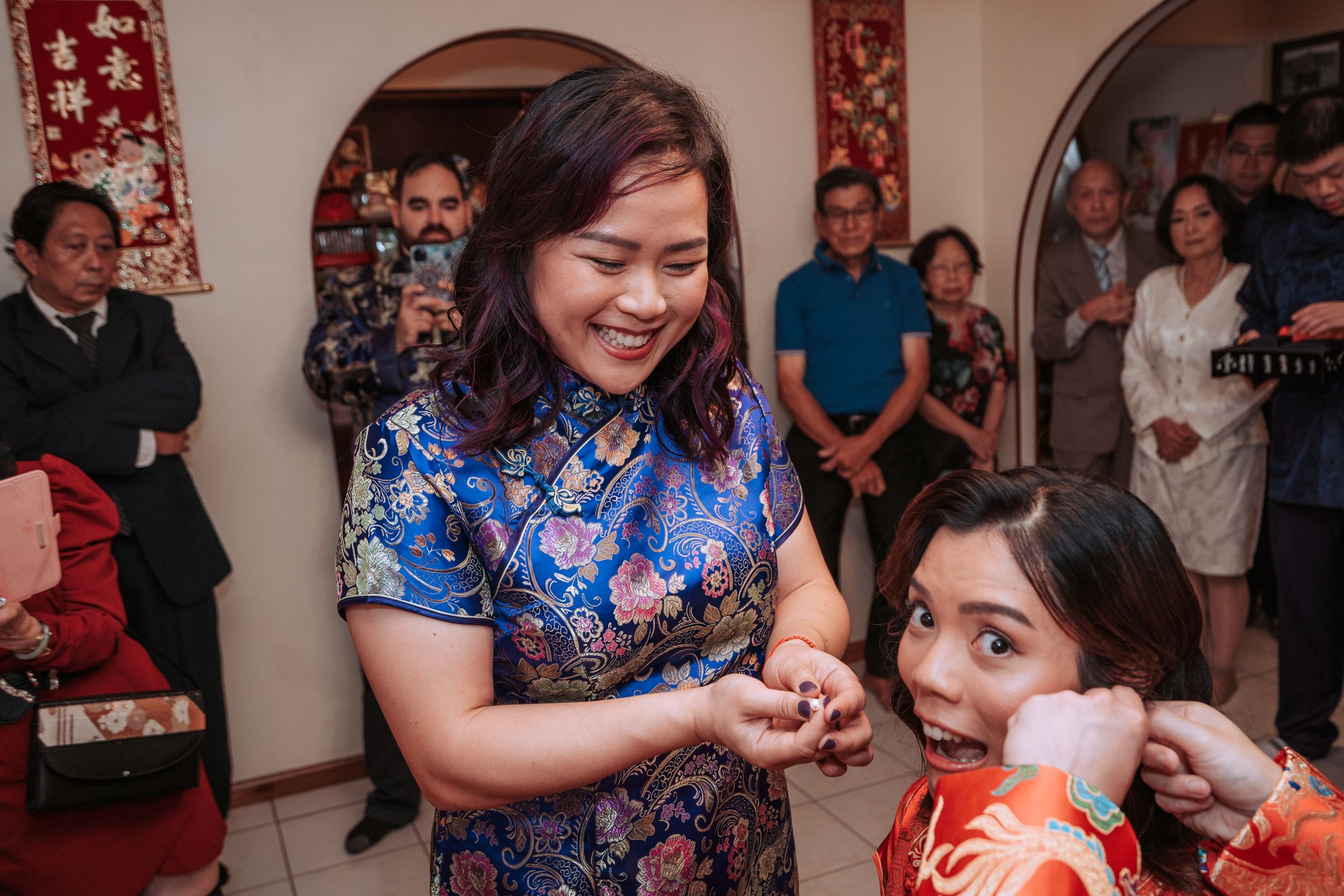 A festive Chinese tea ceremony with traditional dress and decorations.