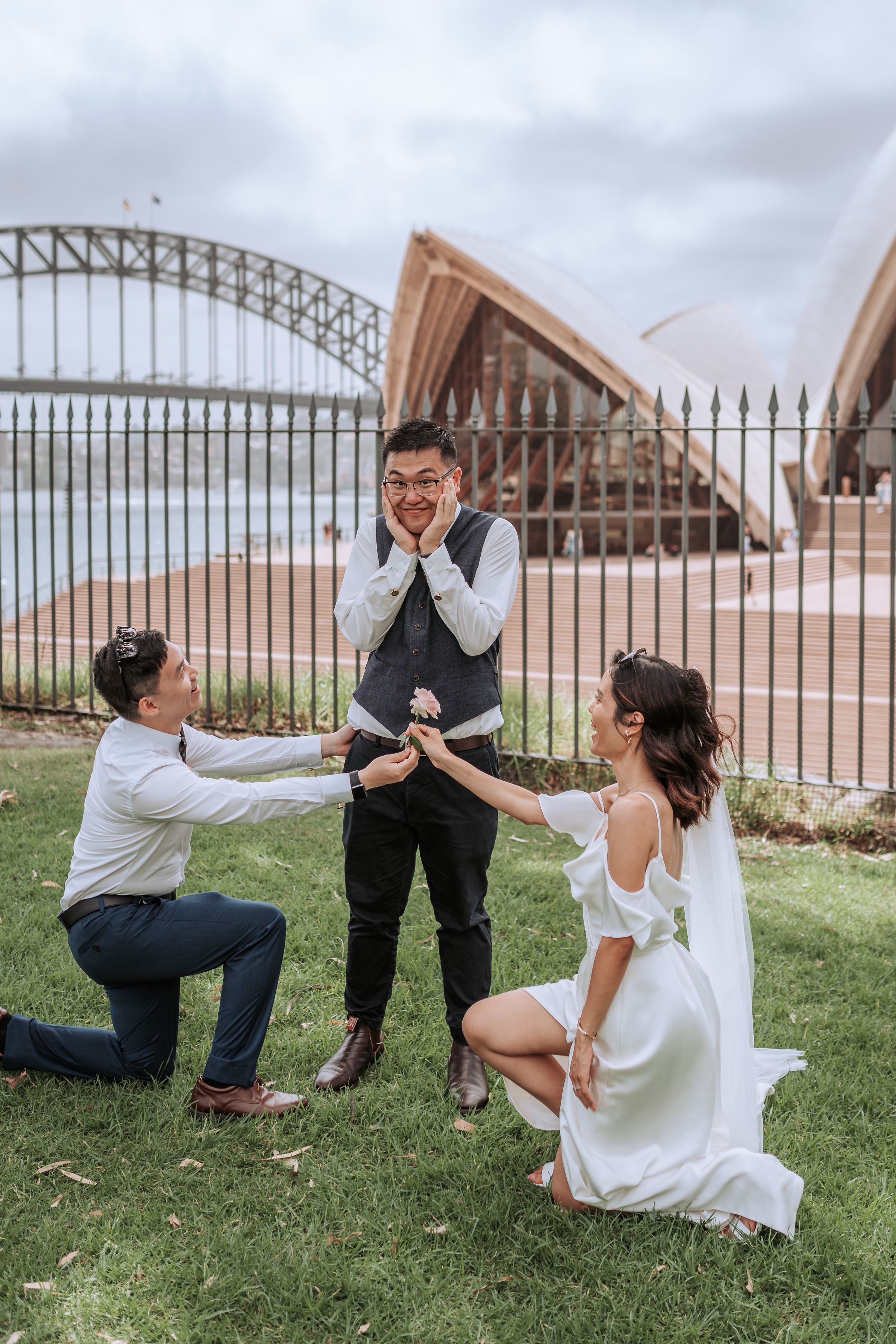 Playful wedding photo near Sydney Opera House with surprise reaction pose.