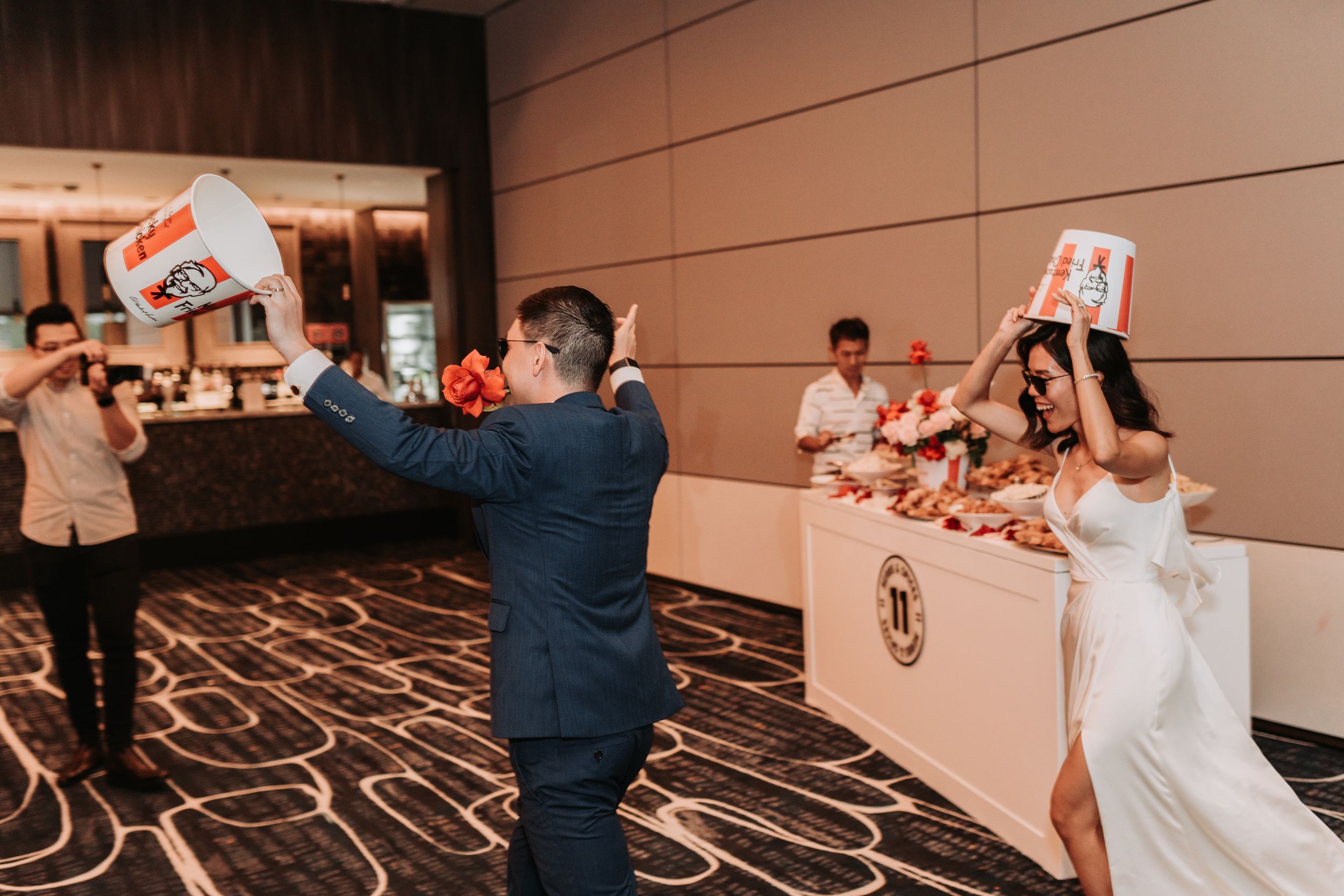Wedding celebration in a banquet hall with guests playing games and having fun.