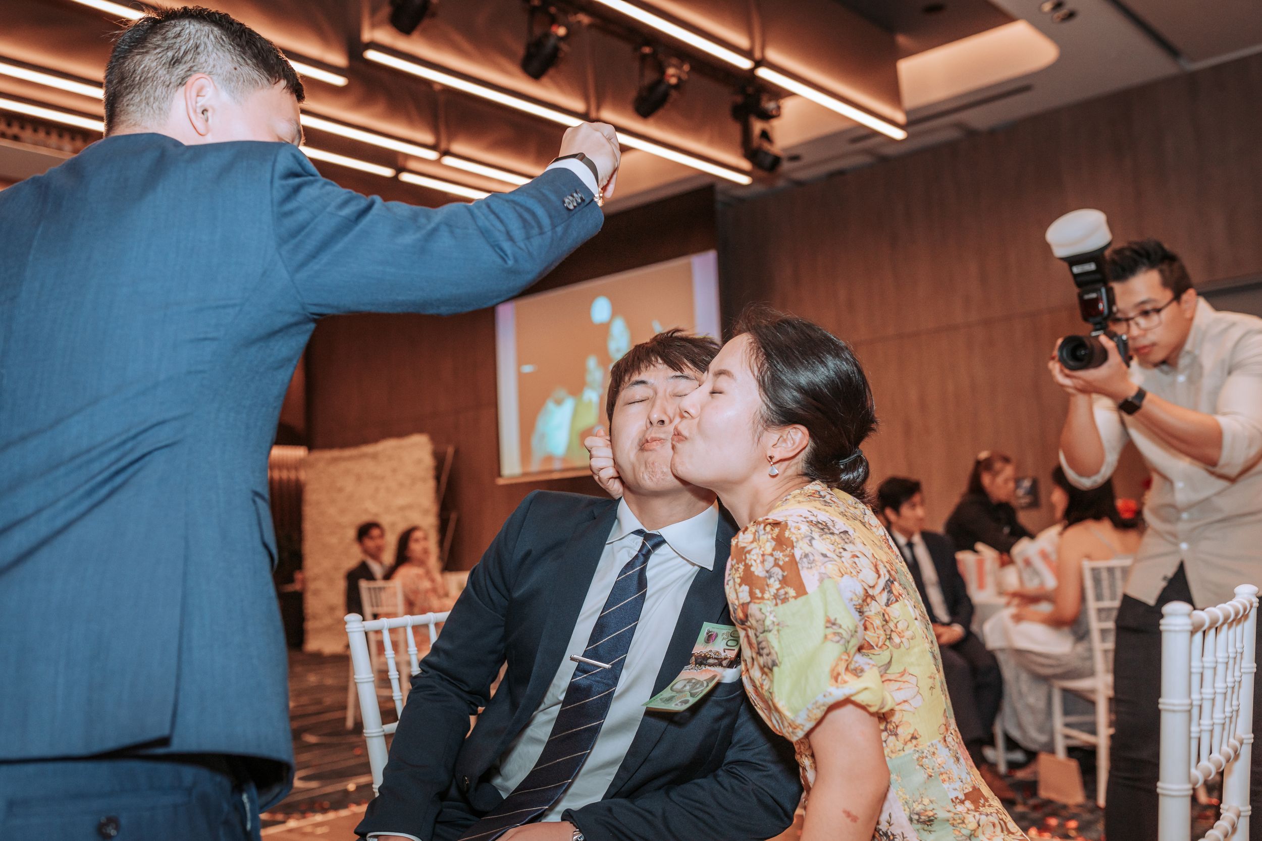 Party guests participate in a fun drinking game at a celebration event.