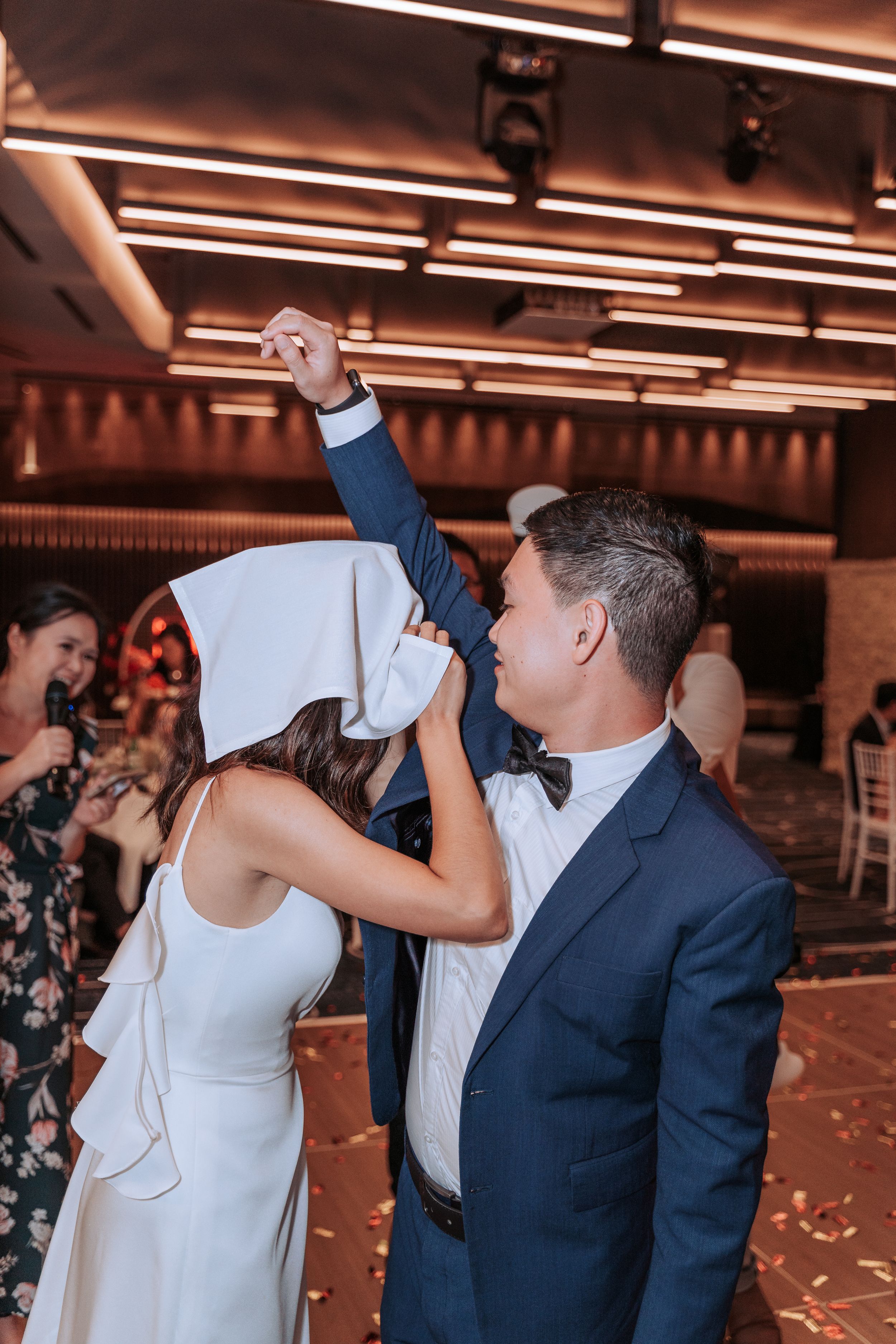 Couple performs a choreographed dance move during their wedding celebration.