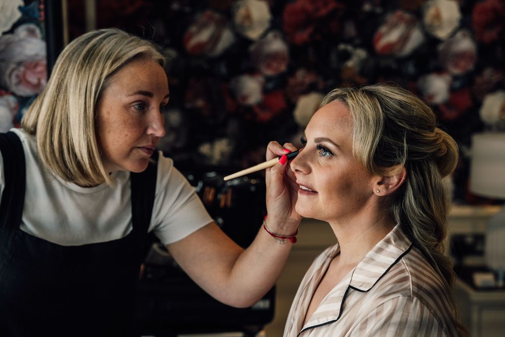 Series of shots showing makeup application during wedding preparations.