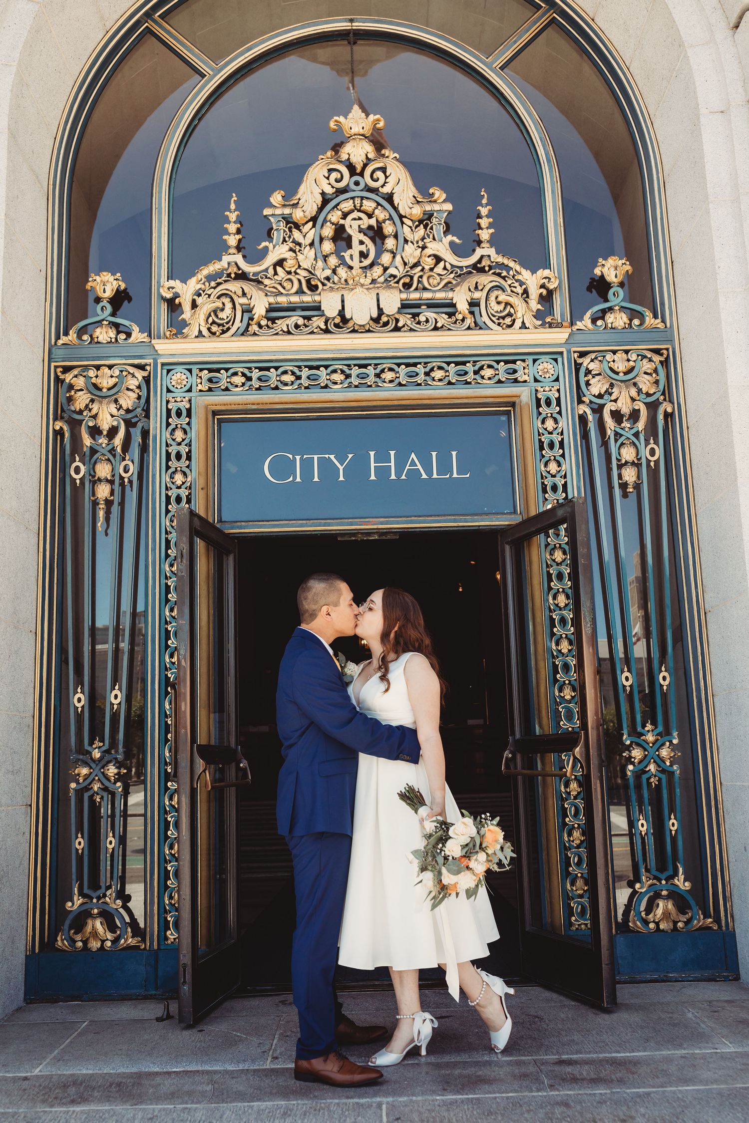A four-panel sequence showing a tender moment at the ornate entrance doors of City Hall.