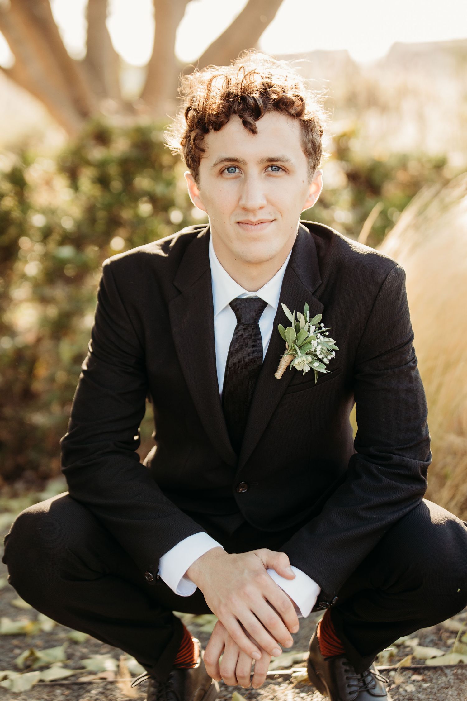 A series of candid portraits showing a person in a black suit with boutonniere sitting outdoors in natural lighting.