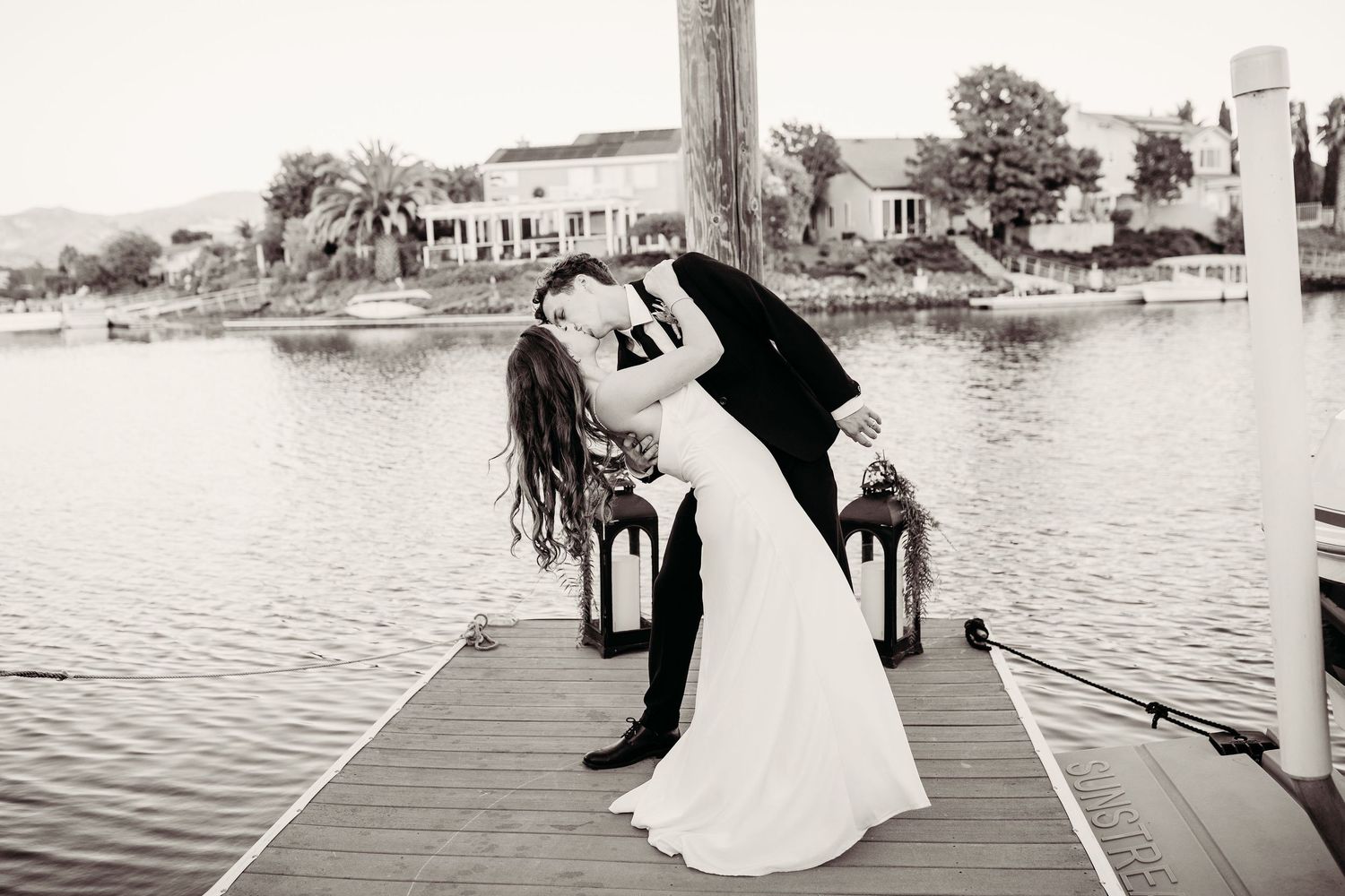 Black and white wedding photo collage showing romantic moments and scenic waterfront views during a traditional celebration.