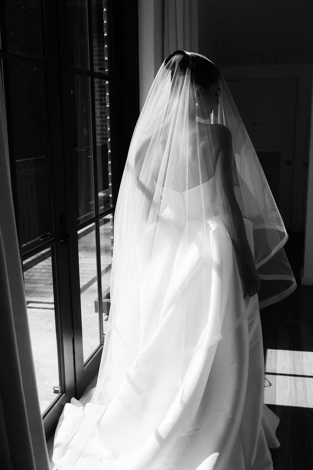 A black and white artistic photo series showing flowing white bridal gown fabric and veil in silhouette against window light.