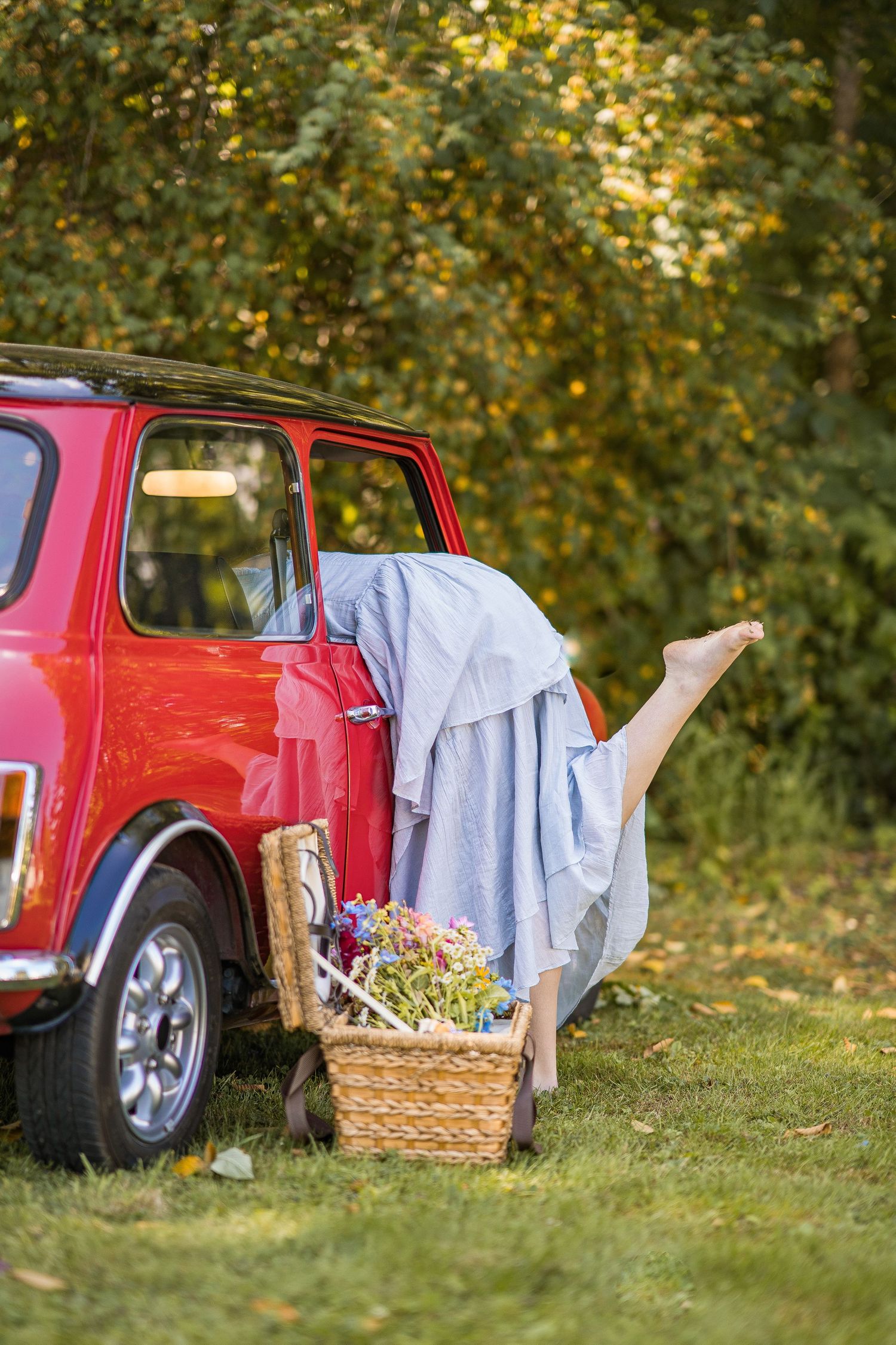styled photography senior mini session with red classic mini Cooper car and seasonal flowers