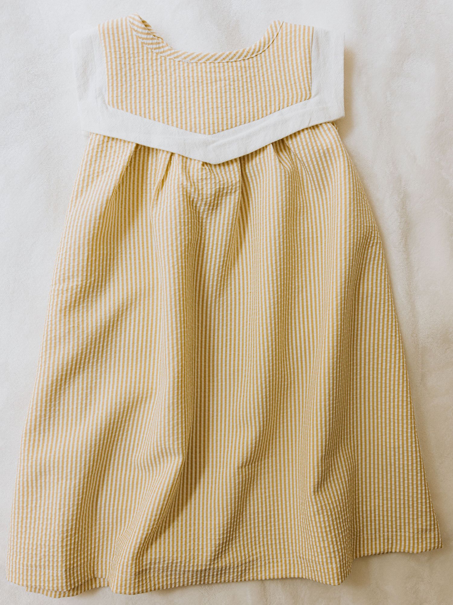 Adorable vintage-inspired baby boy outfit with white button-down shirt, blue striped suspender shorts and matching bowtie.