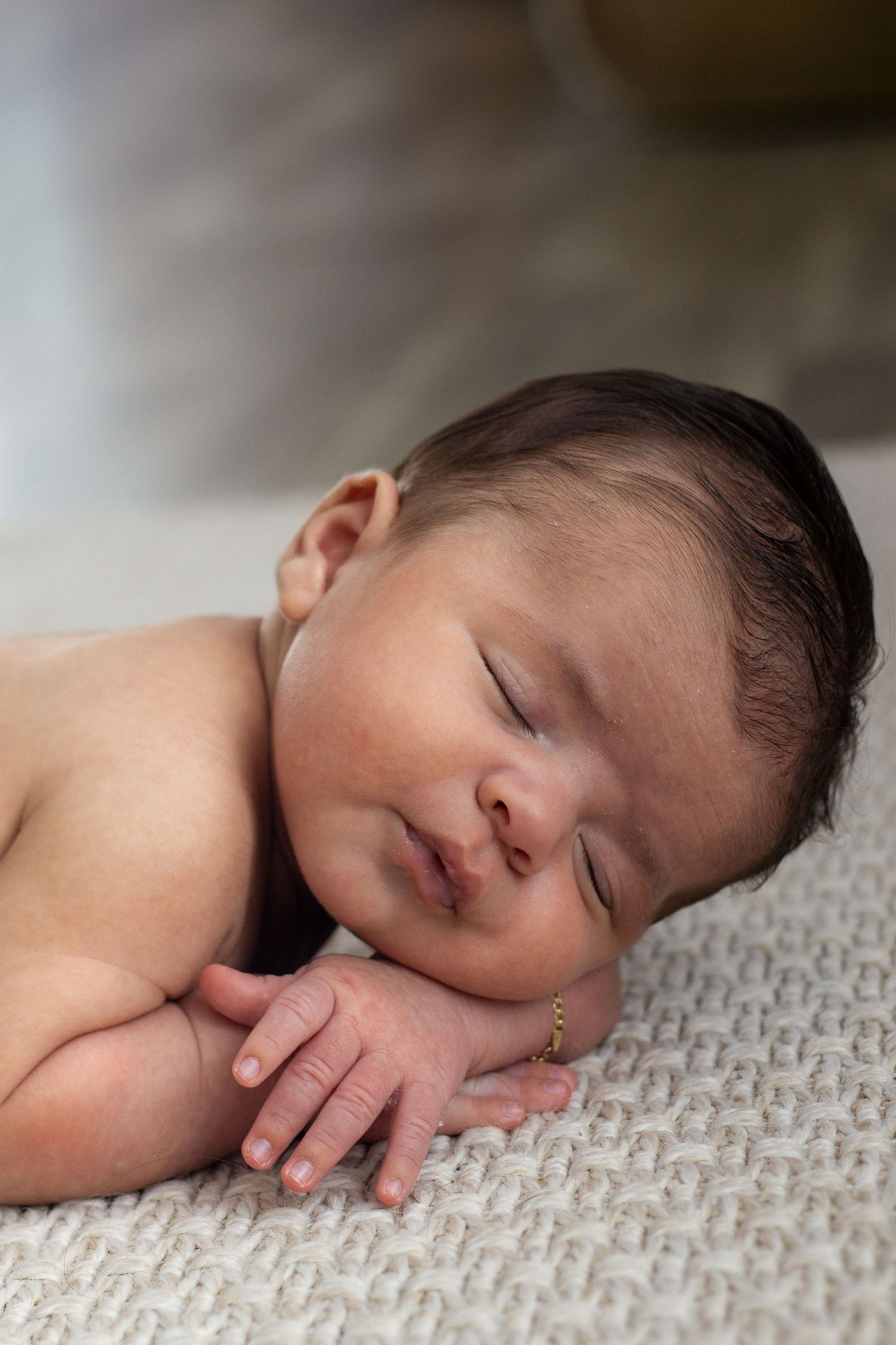 West Michigan Photographer: photo of a newborn baby resting in a pink swaddle in a basket