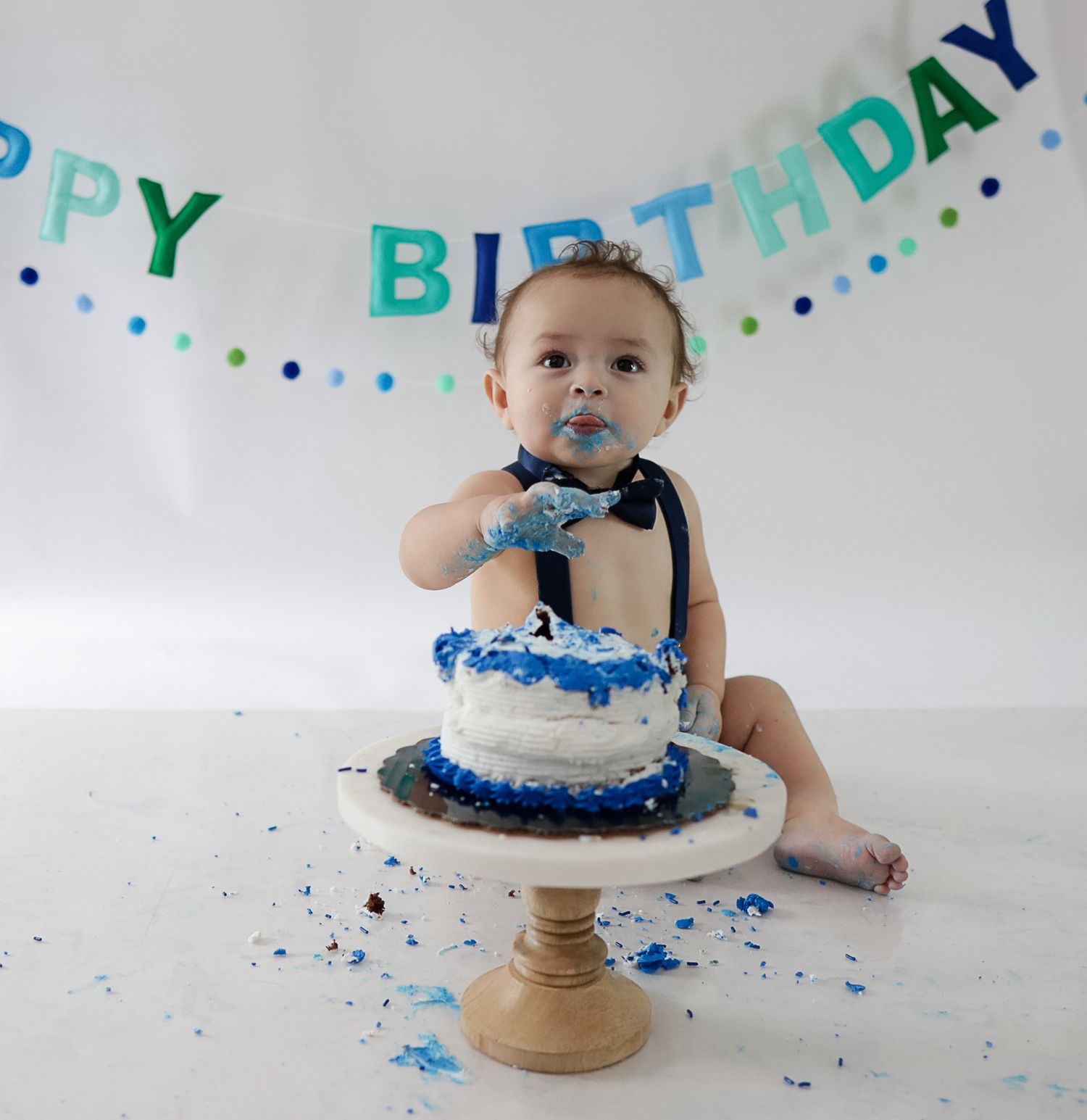 West Michigan Photographer: photo of a birthday boy eating his cake smash cake