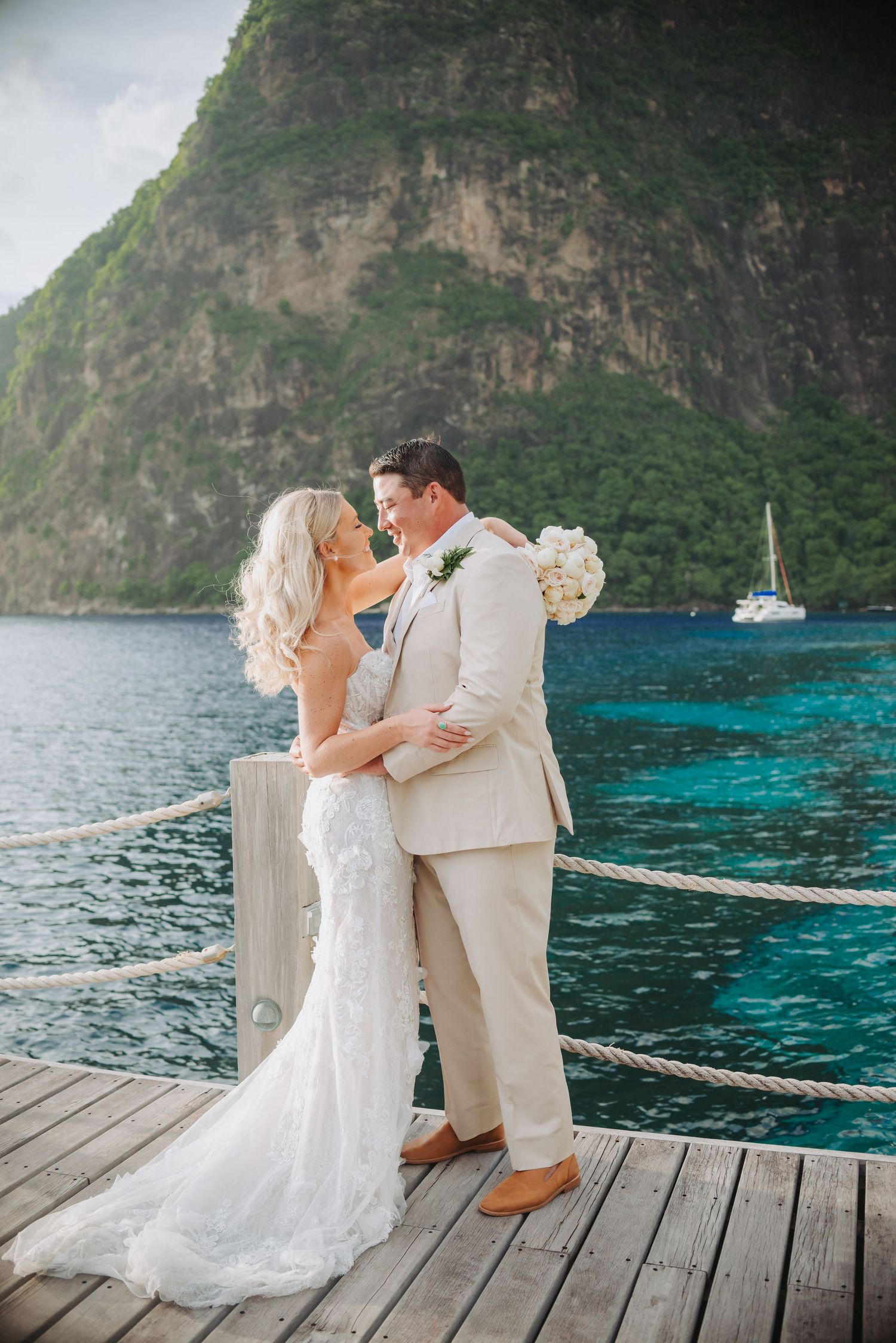 St Lucia wedding photographer captures Vow renewal destination wedding at Sugar Beach Viceroy; couple kisses in front to Piton