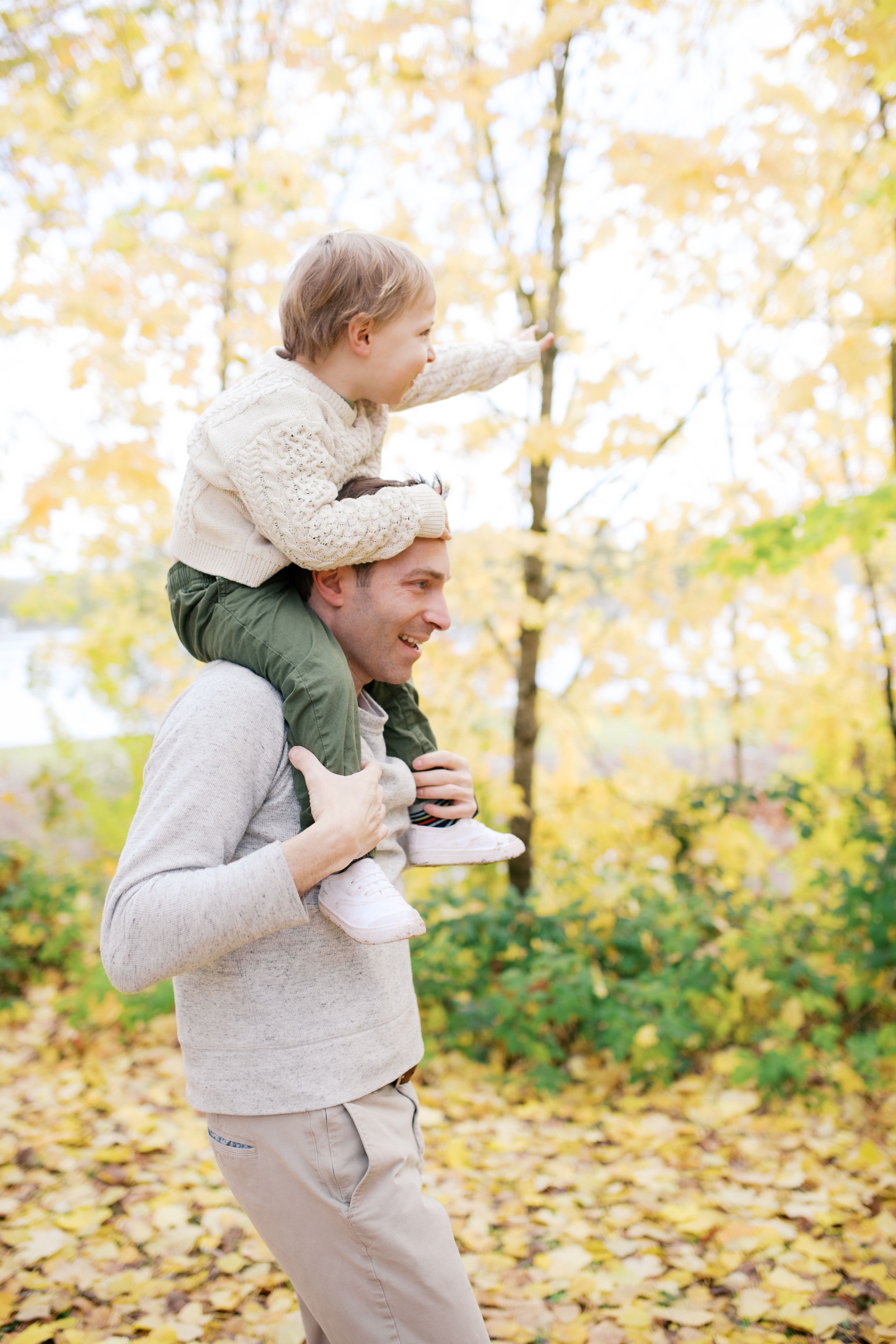 Playful autumn photo sequence shows figure in light gray sweater dancing in fallen leaves outdoors.
