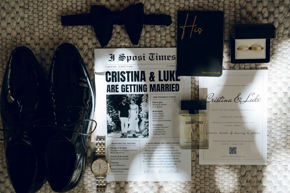 Wedding details flatlay with newspaper announcement, shoes, watch and other accessories.