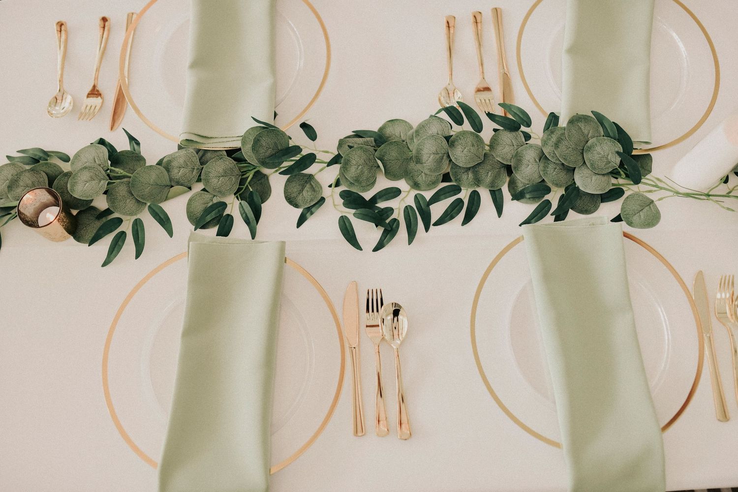 Long tables decorated with eucalyptus runners and florals