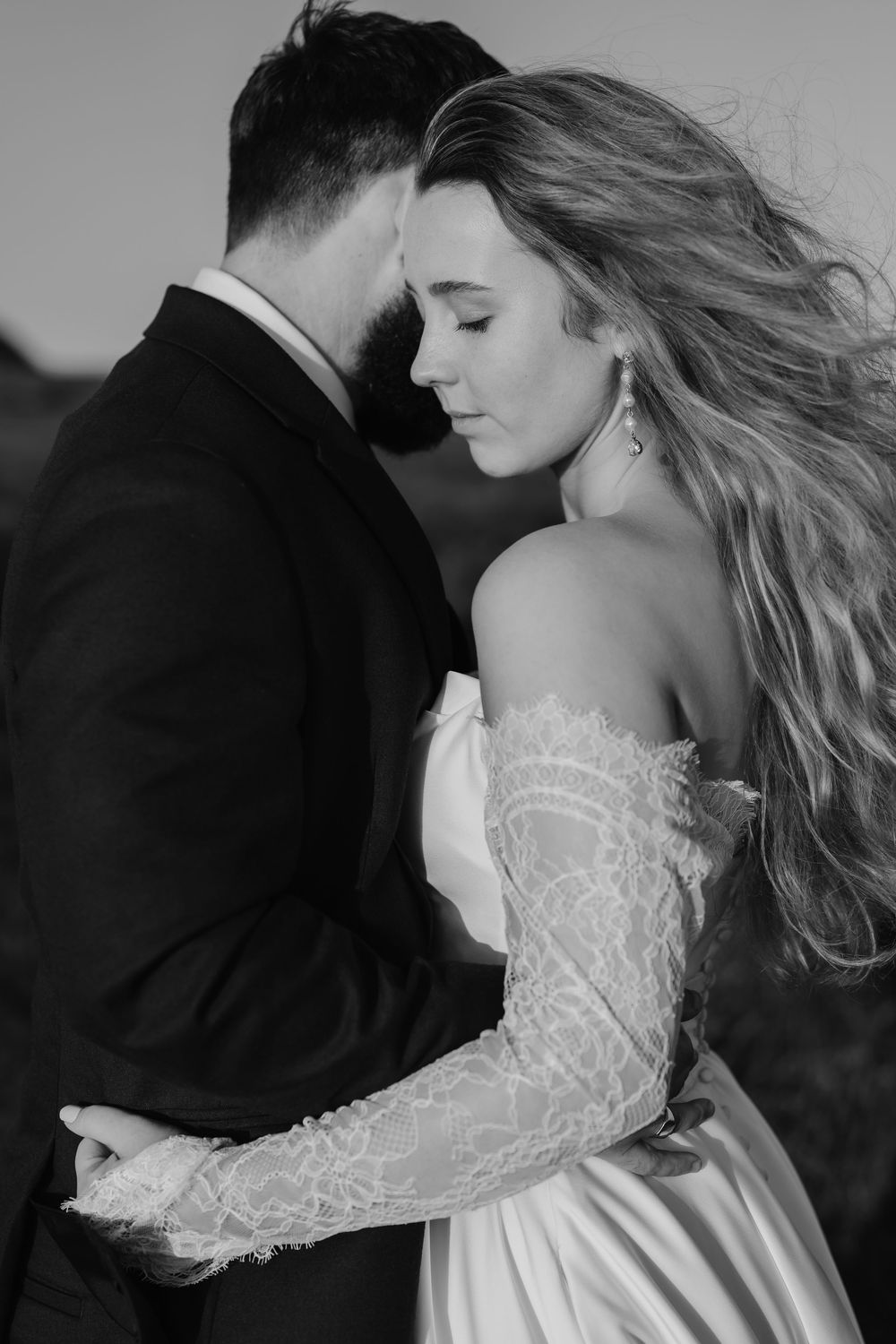 Romantic black and white portraits showcasing intricate lace wedding dress details.