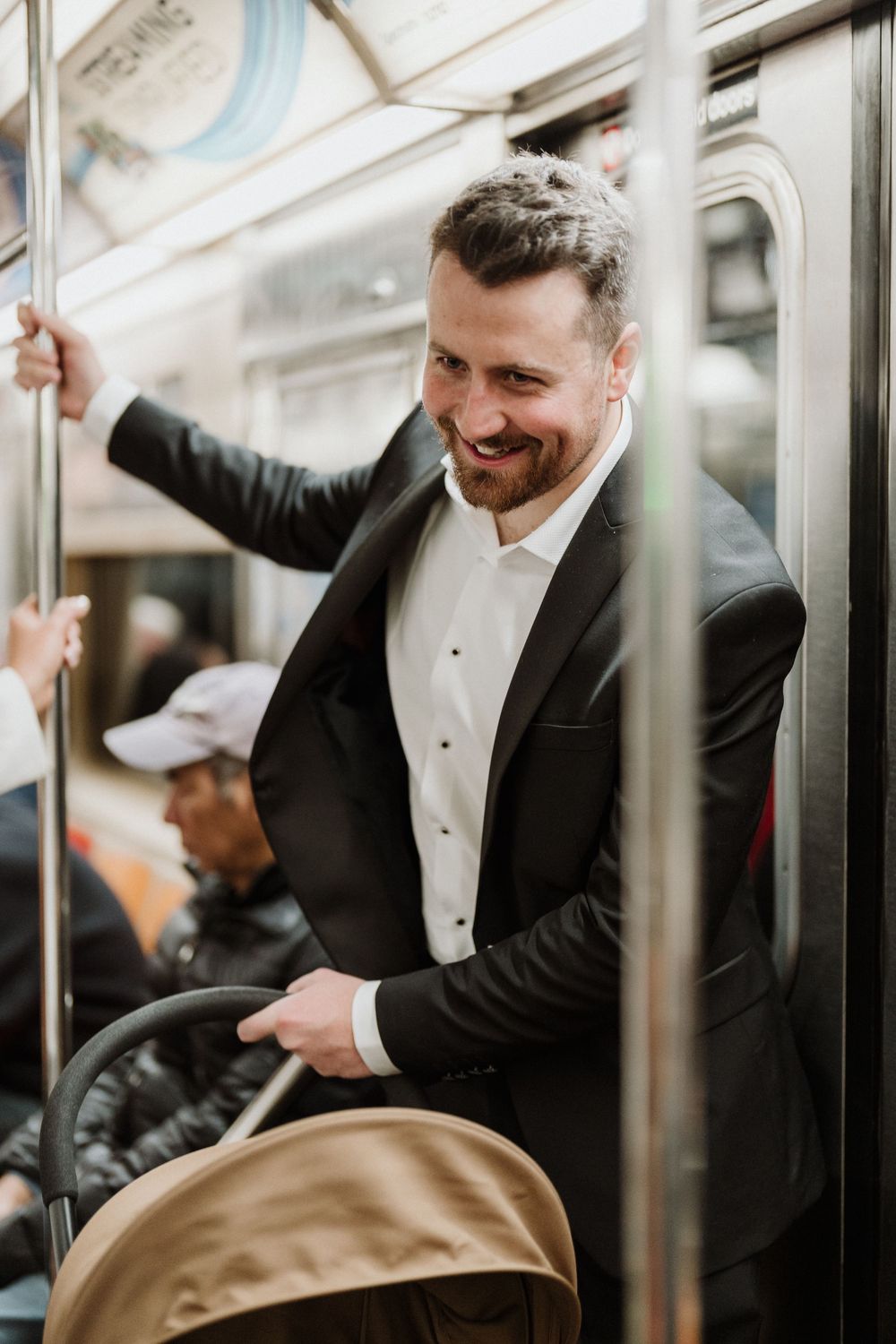 Candid moments of a groom in formal attire on a subway train.