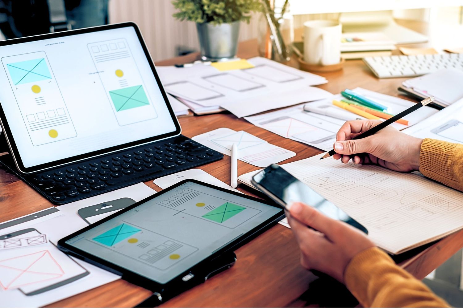 Person using tablet device to review email messages and digital communications at desk with paperwork.