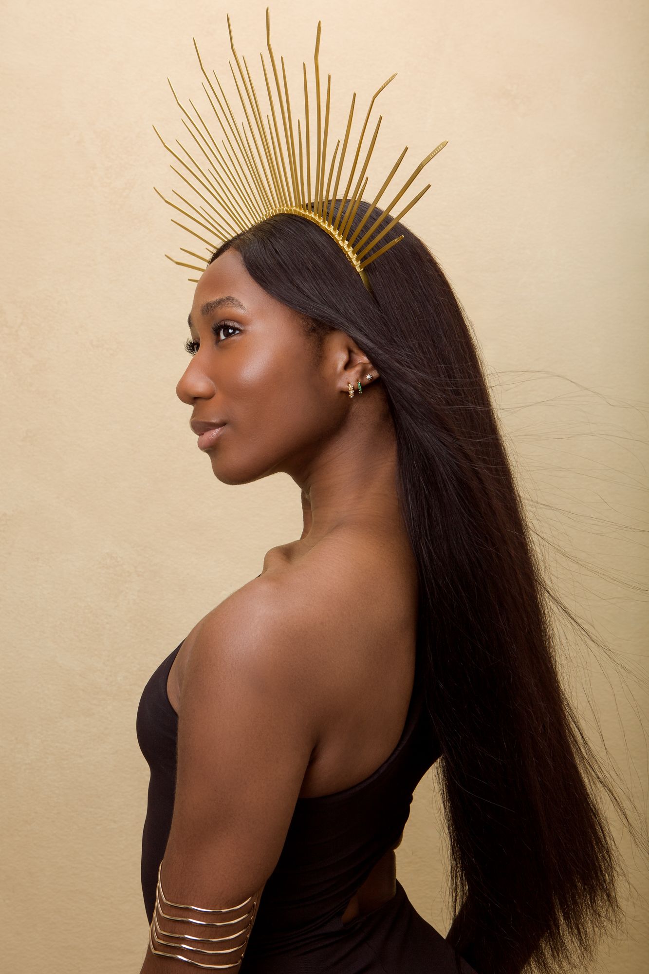 Fashion portrait series showing artistic poses against beige backdrop with golden sunburst crown accessory.