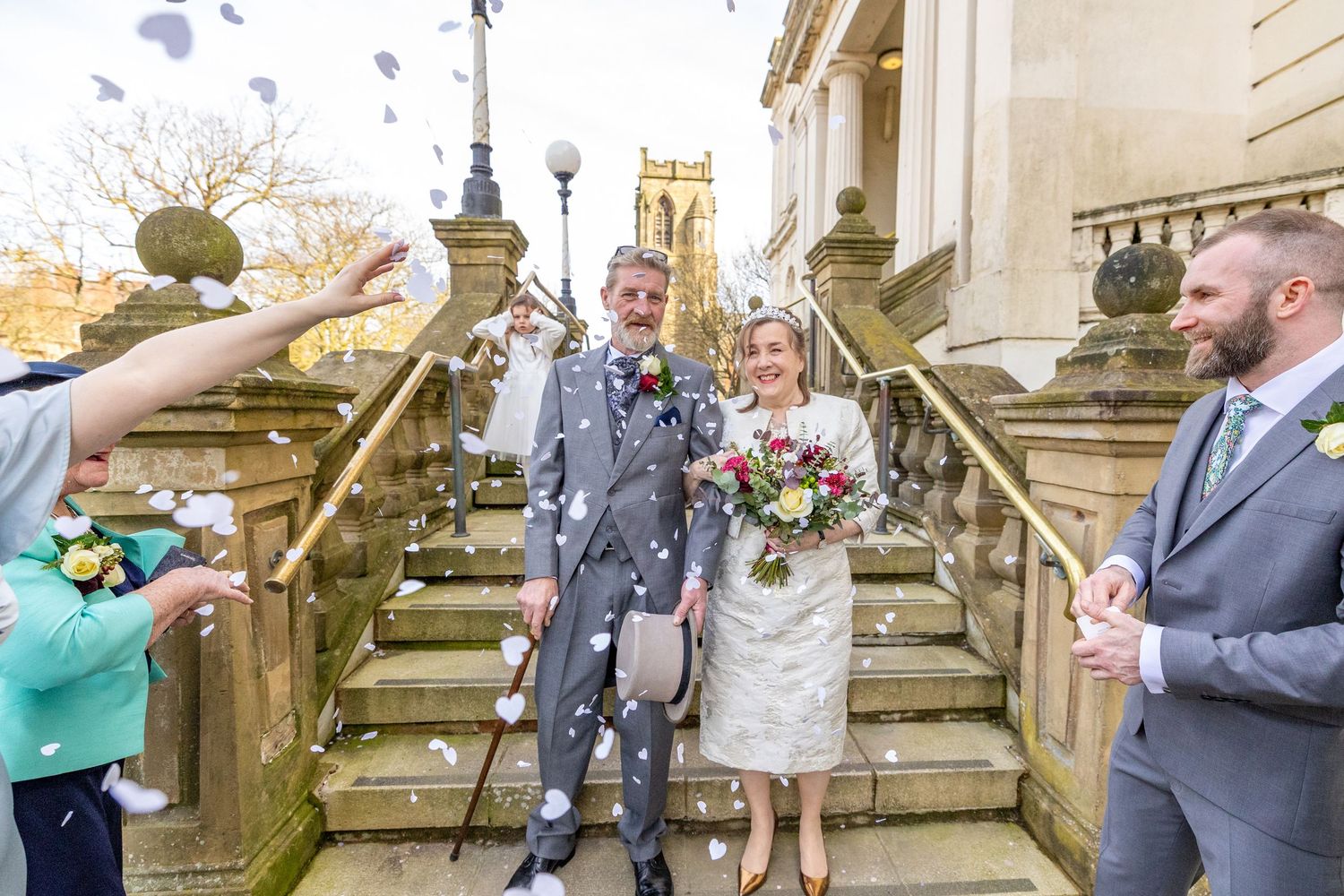 Confetti moment on the steps of Southport Town Hall, newlyweds smiling as guests celebrate their wedding in Southport
