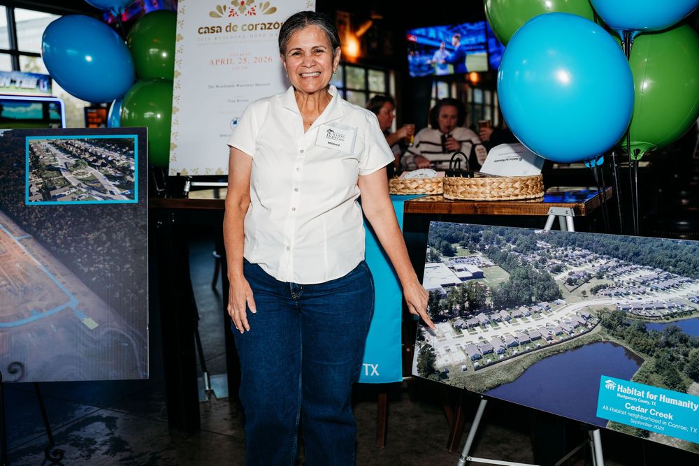 Professional standing by presentation displays with blue and green balloons in an office setting.