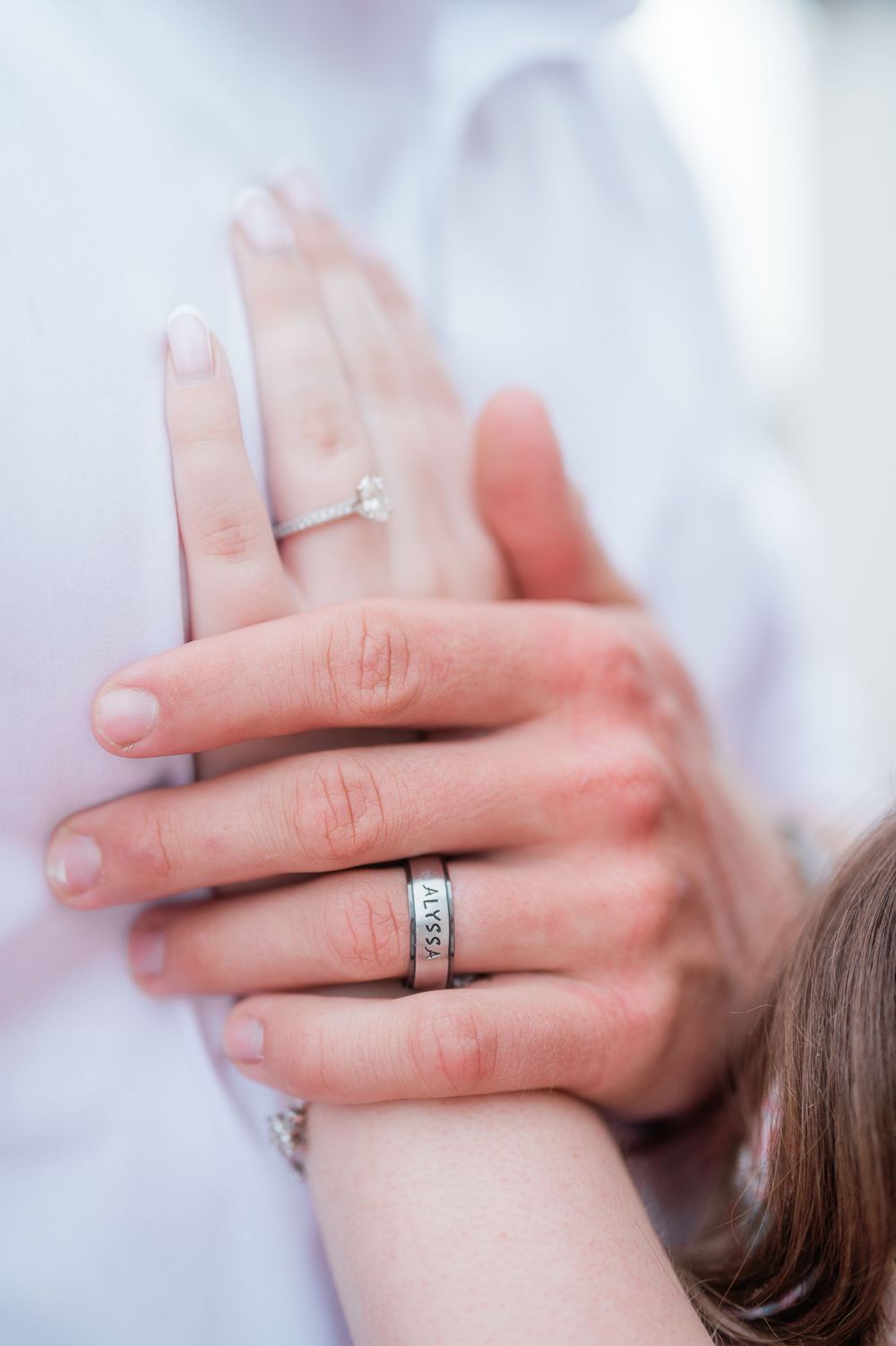 Close-up shots of hands wearing wedding rings against a soft white background.