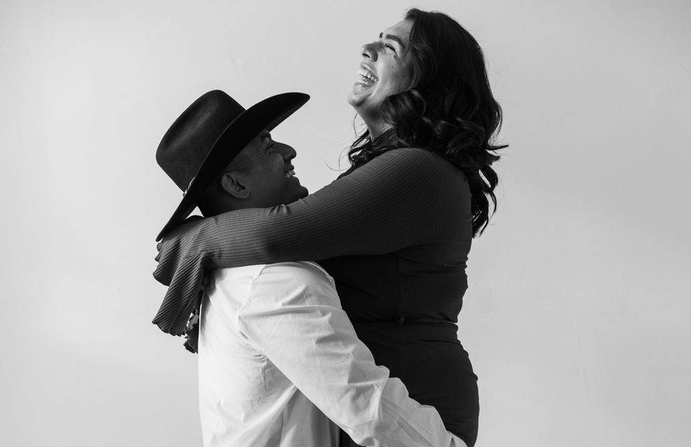 A black and white photo series showing silhouettes of two people embracing in different poses.