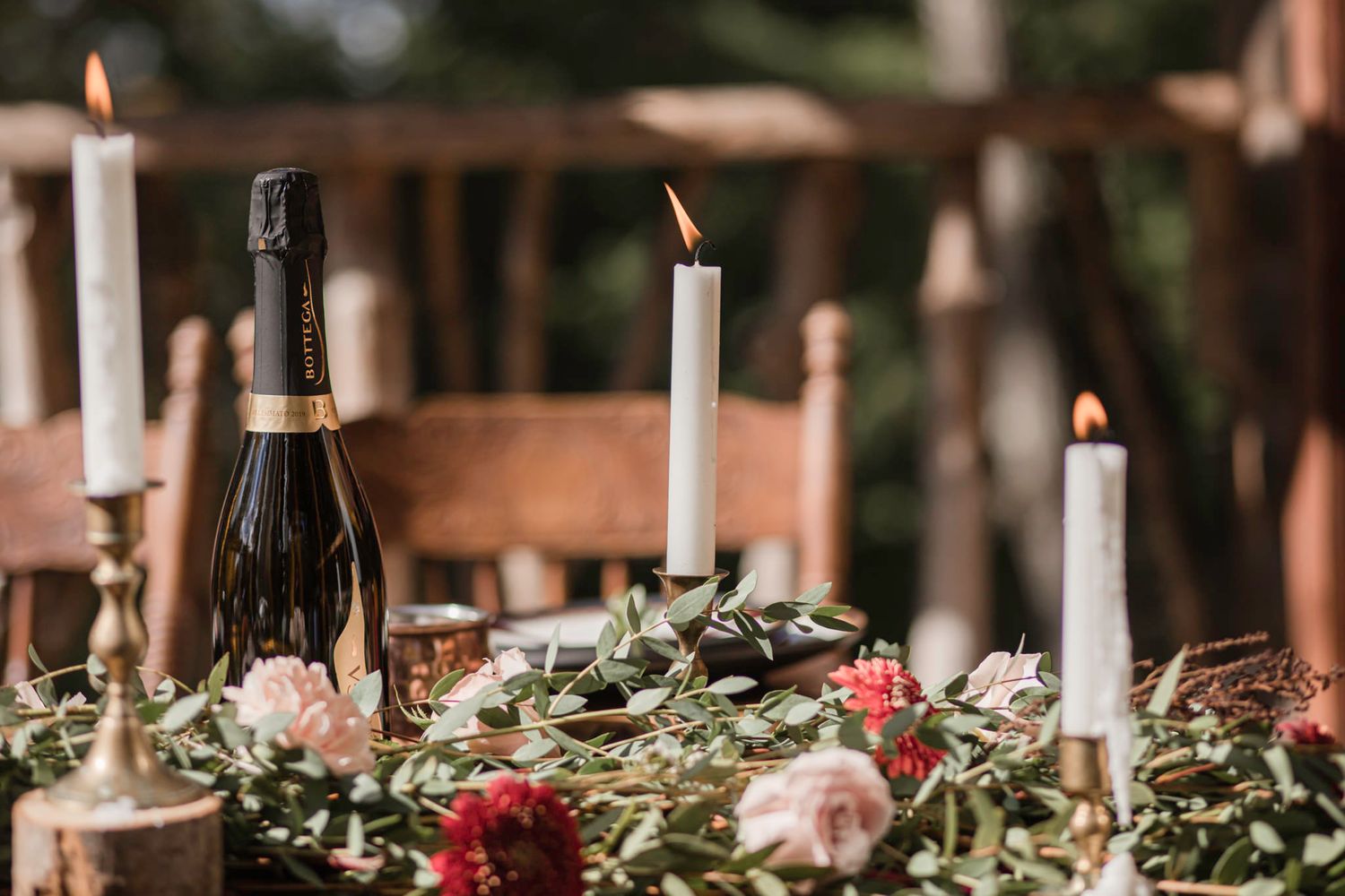 candles clicker in the breeze at on an outdoor set table in the forest, at a mountain treehouse elopement mont tremblant quebec canada