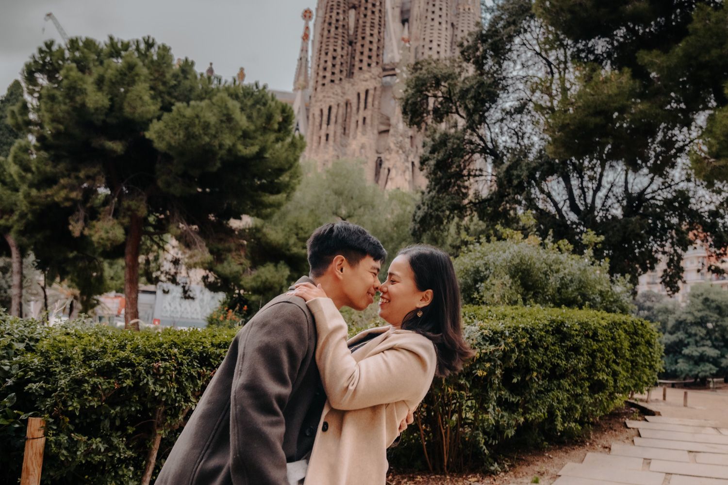 Loving couple framed by fountain columns Engagement photoshoot Barcelona BarcelonaLoversPH