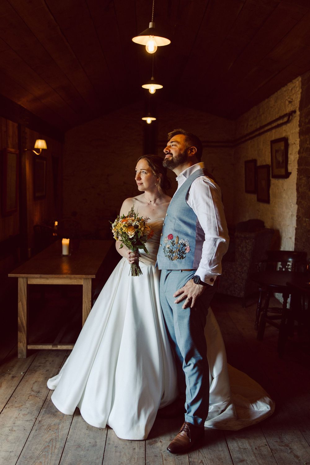 A sequence of wedding photos showing a couple in a rustic indoor setting with wooden floors and vintage lighting.