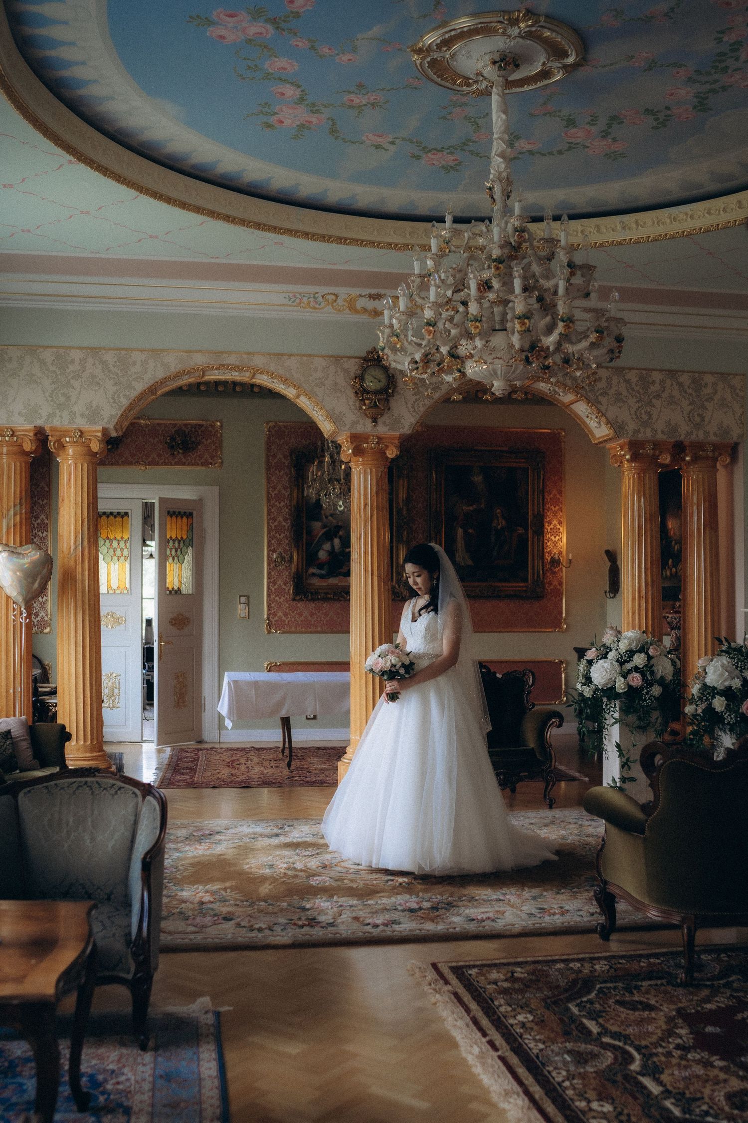 bride standing in elegant historic manor interior romantic wedding portrait Finland